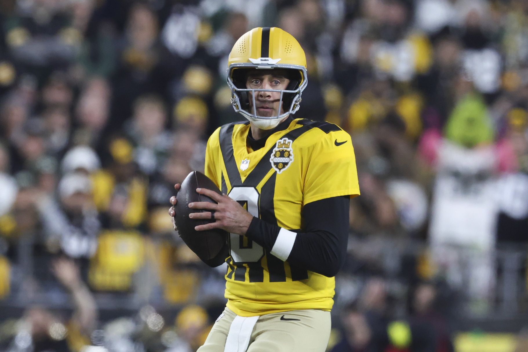 Pittsburgh Steelers quarterback Aaron Rodgers (8) looks to pass against the Green Bay Packers during the first quarter at Acrisure Stadium.