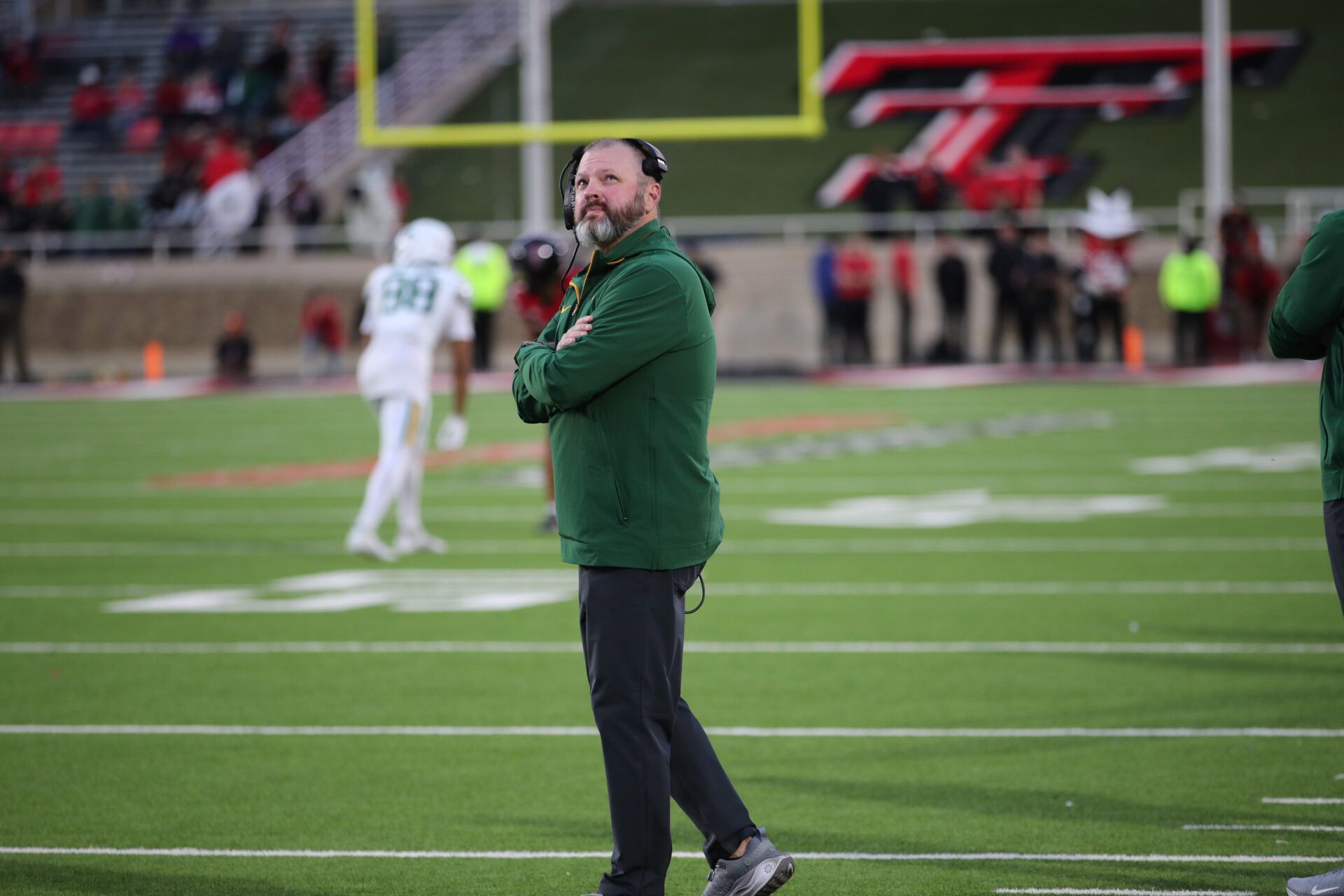 Baylor Bears assistant coach Mason Miller watches the big screen in the second half during the game against the Texas Tech Red Raiders at Jones AT&T Stadium and Cody Campbell Field.