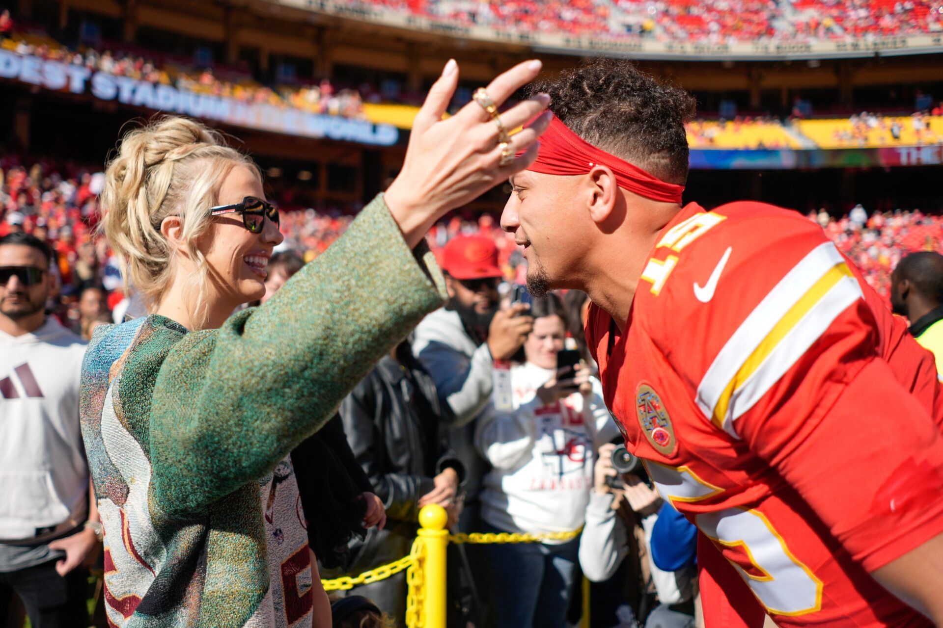 Kansas City Chiefs quarterback Patrick Mahomes (15) greets wife, Brittany, prior to the game against the Las Vegas Raiders at GEHA Field at Arrowhead Stadium.