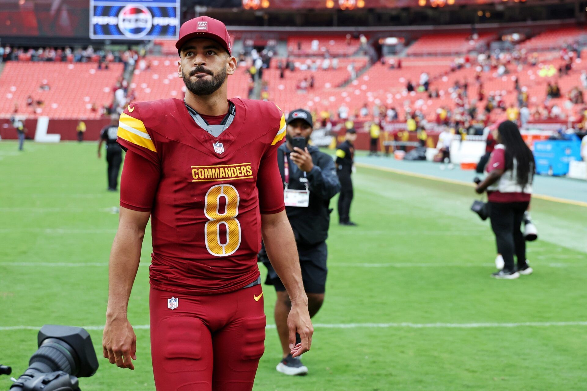 Washington Commanders quarterback Marcus Mariota (8) walks off the field after the game against Las Vegas Raiders at Northwest Stadium.