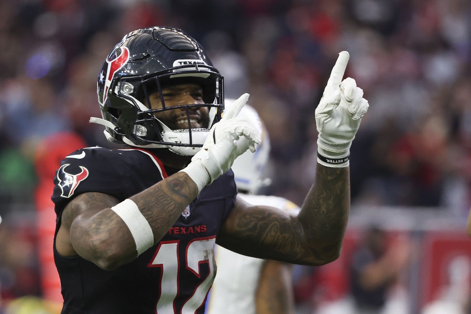 Houston Texans wide receiver Nico Collins (12) reacts to a first down against the Los Angeles Chargers in the second quarter in an AFC wild card game at NRG Stadium.