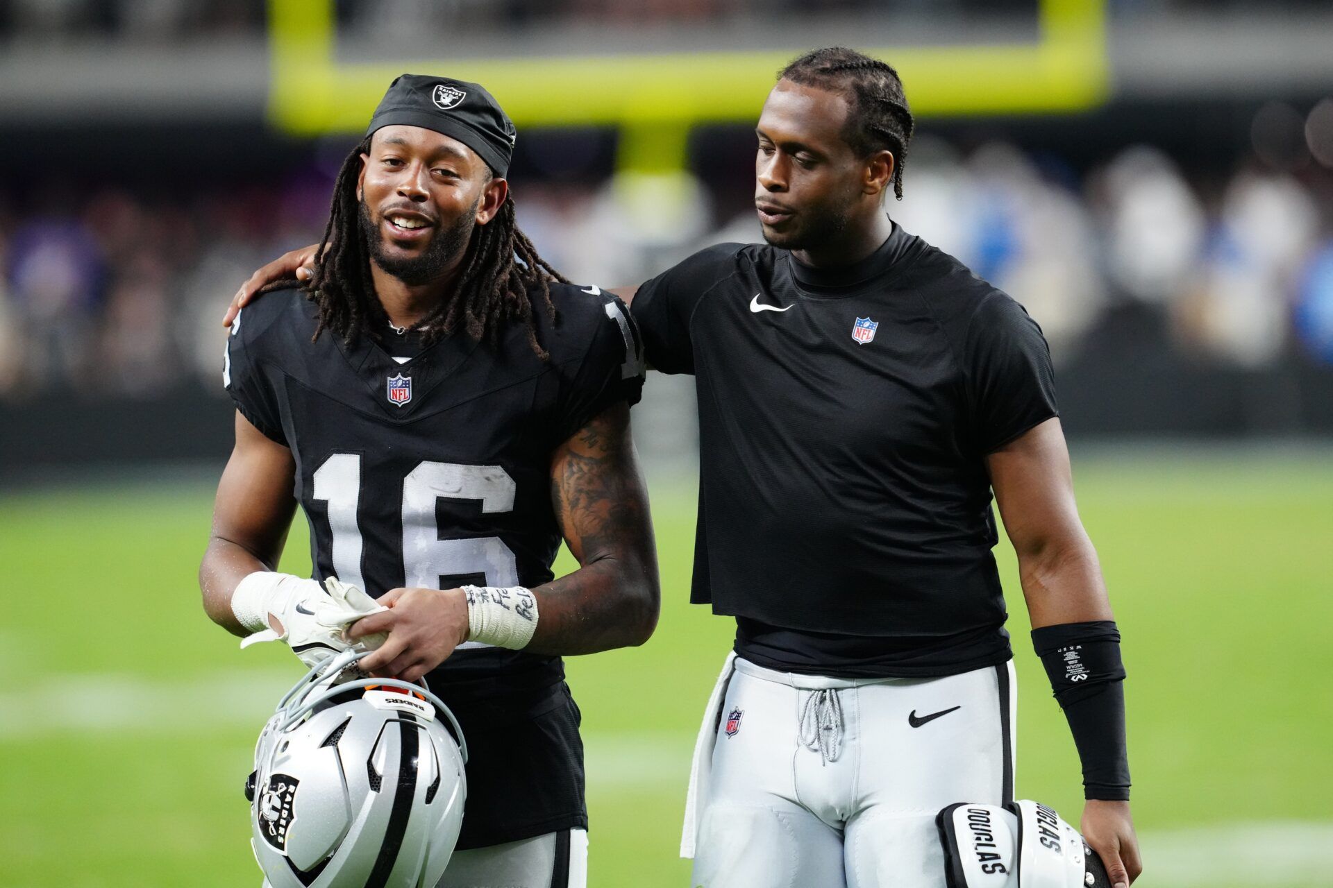 Las Vegas Raiders wide receiver Jakobi Meyers (16) and Las Vegas Raiders quarterback Geno Smith (7) walk off the field after the game at Allegiant Stadium.