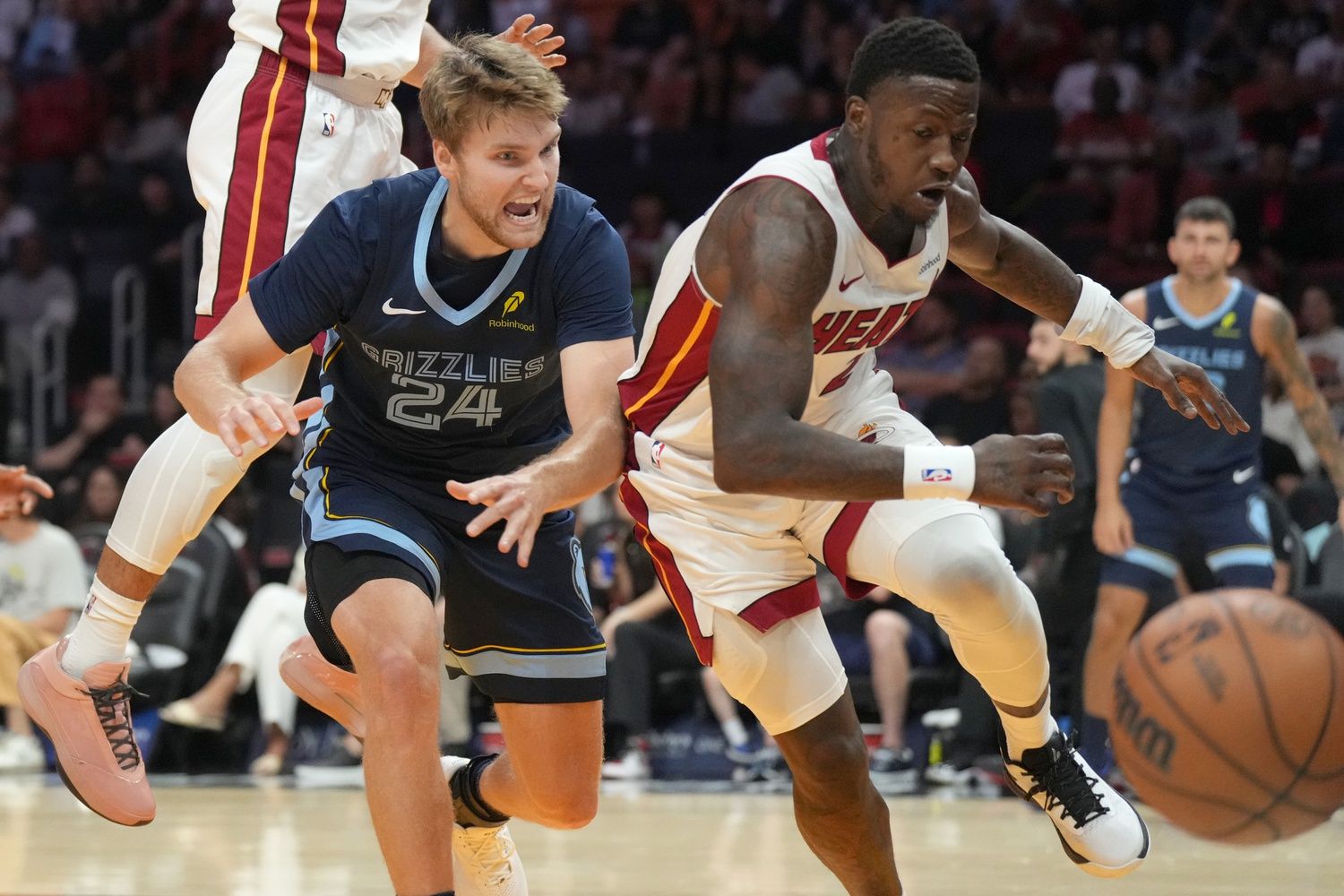 Memphis Grizzlies guard Cam Spencer (24) and Miami Heat guard Terry Rozier (2) battle for a loose ball during the second half at Kaseya Center.
