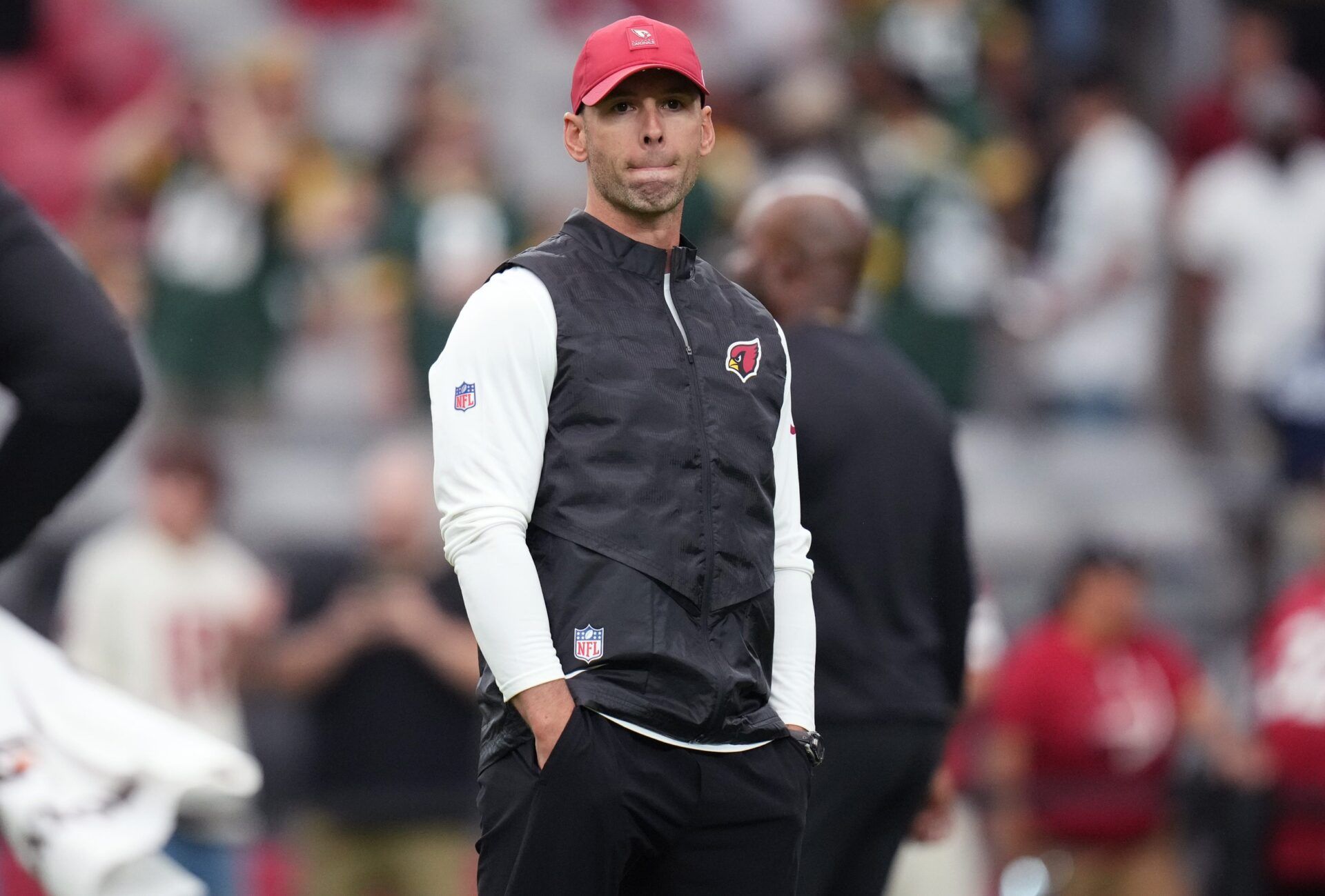Arizona Cardinals head coach Jonathan Gannon watches as his team warms up before playing against the Green Bay Packers at State Farm Stadium in Glendale on Oct. 19, 2025.