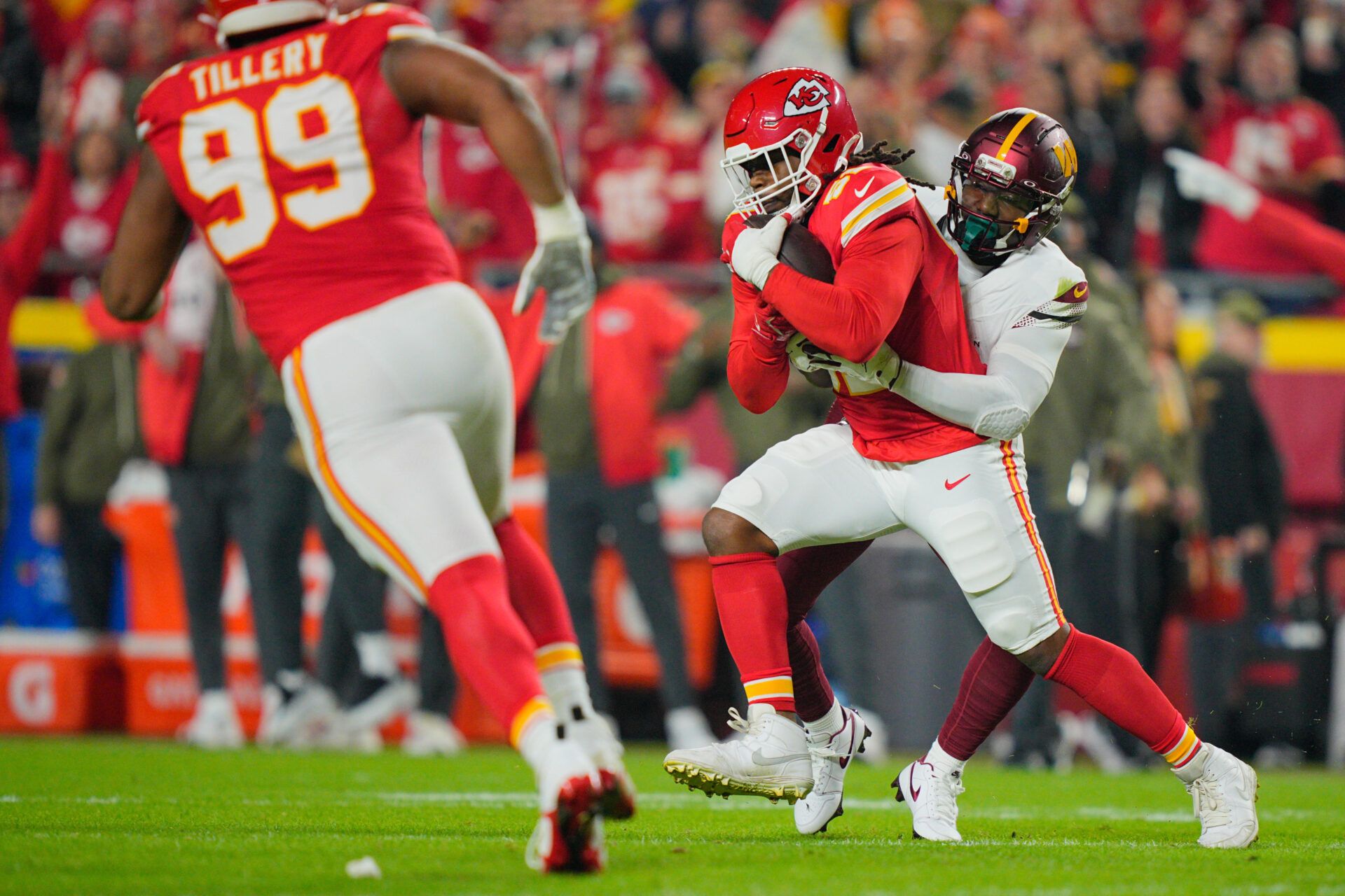 Washington Commanders wide receiver Deebo Samuel Sr. (1) tackles Kansas City Chiefs defensive end Michael Danna (51) after an interception during the first quarter of the game at GEHA Field at Arrowhead Stadium.