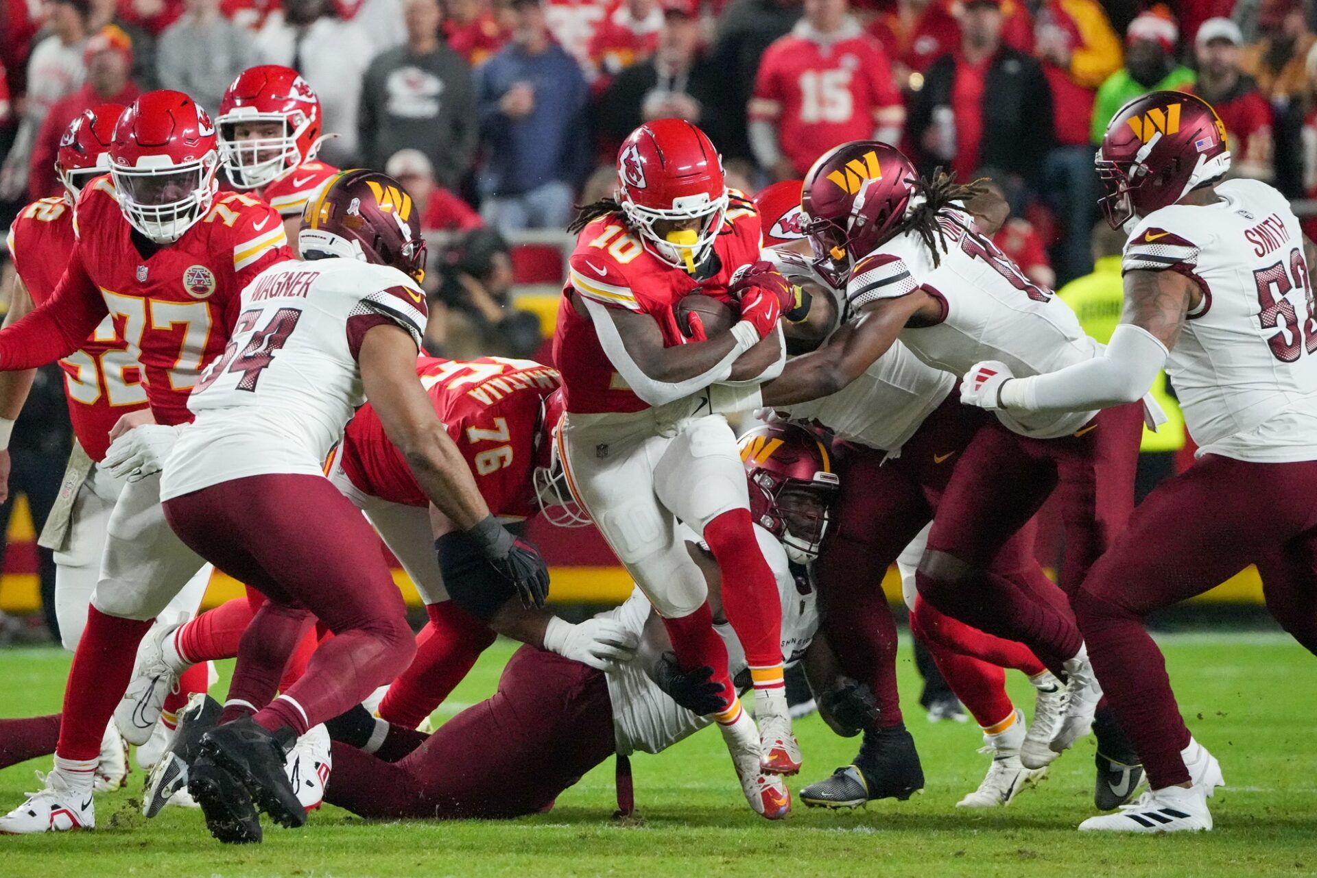 Kansas City Chiefs running back Isiah Pacheco (10) carries the ball against the Washington Commanders during the second quarter of the game at GEHA Field at Arrowhead Stadium.