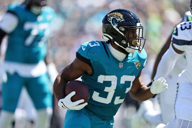 Jacksonville Jaguars running back Bhayshul Tuten (33) runs the ball during the first half against the Seattle Seahawks at EverBank Stadium.