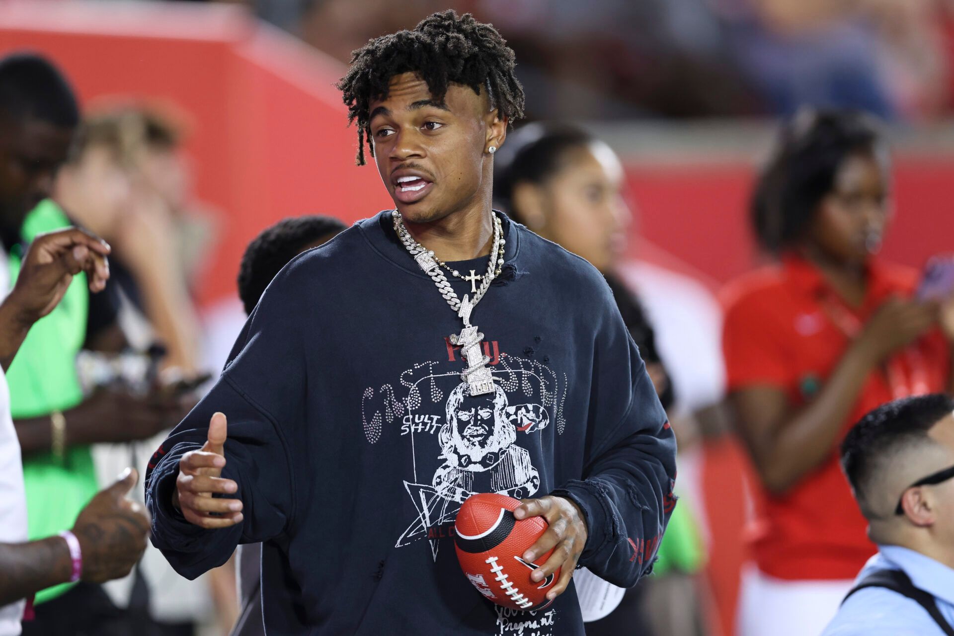 Houston Texans wide receiver Tank Dell talks on the sideine during the game between the Houston Cougars and the Colorado Buffaloes at TDECU Stadium.