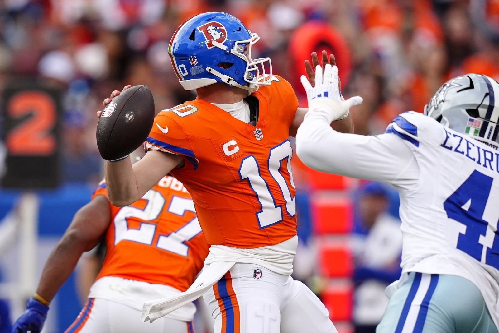 Denver Broncos quarterback Bo Nix (10) throws a pass against Dallas Cowboys defensive end Donovan Ezeiruaku (41) in the second half at Empower Field at Mile High.
