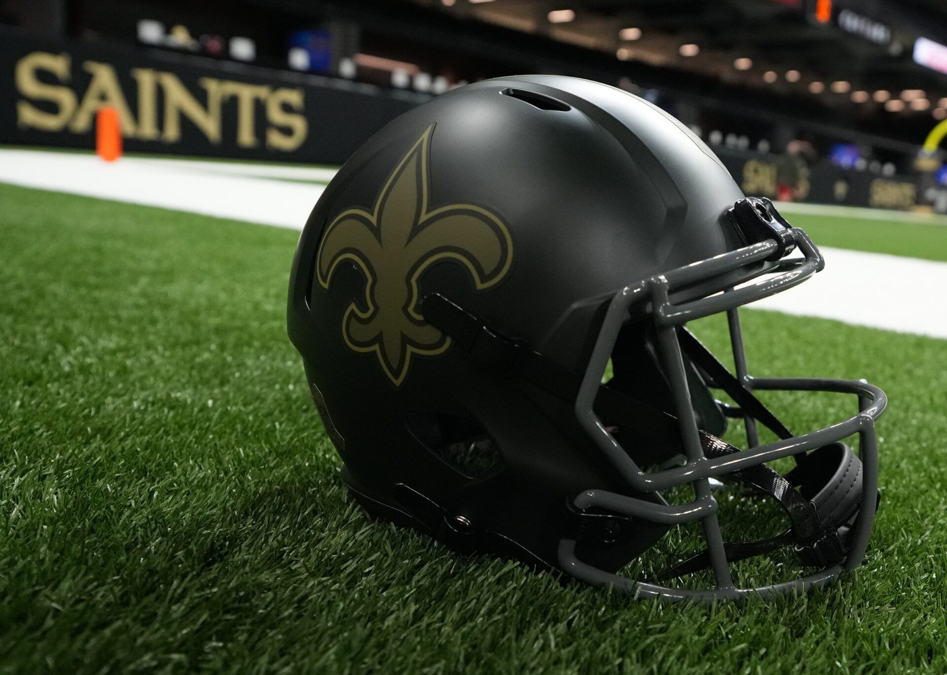 A New Orleans Saints helmet is seen on the field prior to a game against the Tampa Bay Buccaneers at Caesars Superdome.