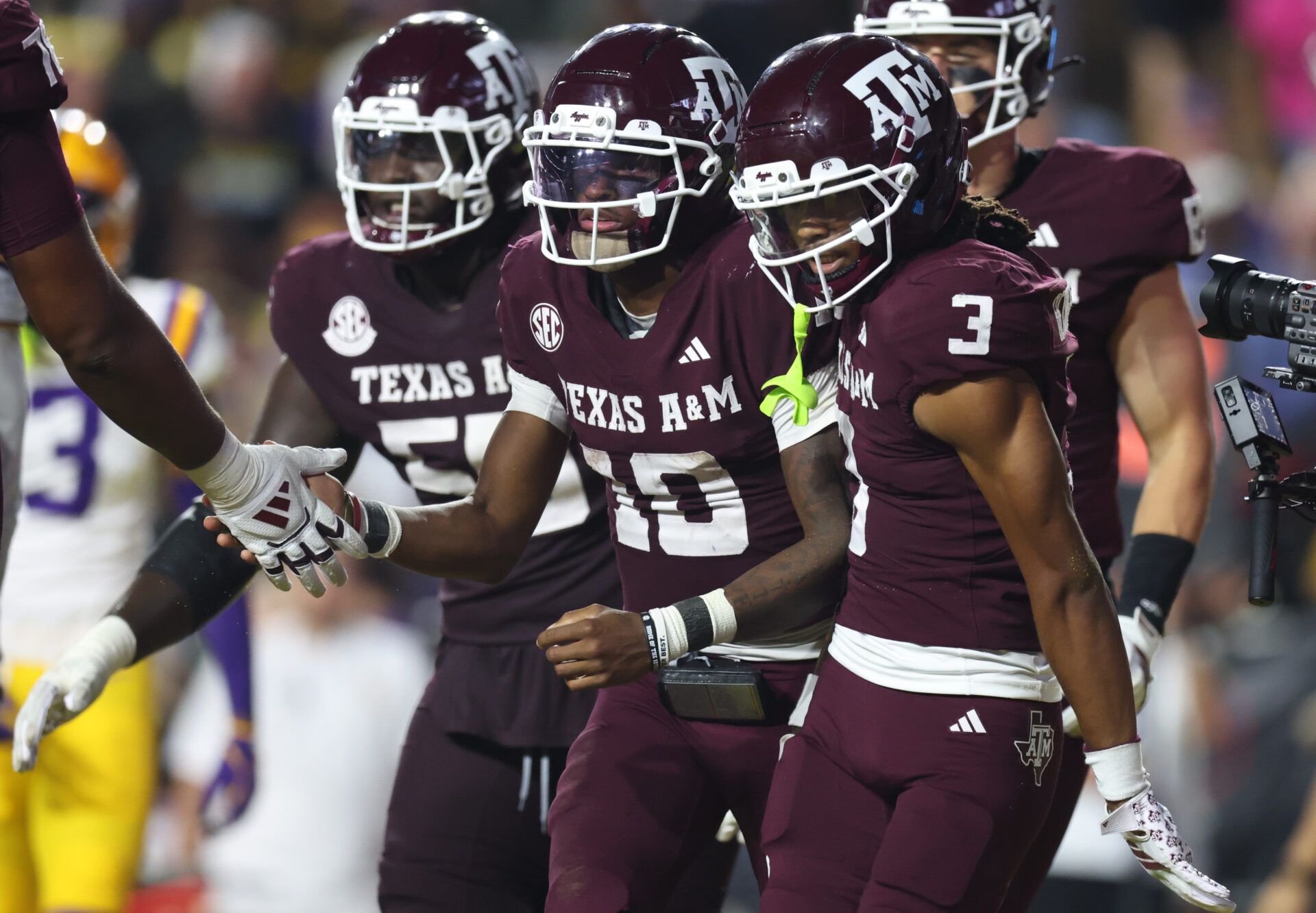 Texas A&M Aggies quarterback Marcel Reed (10) celebrates with wide receiver Ashton Bethel-Roman (3) after a play during the second half against the Louisiana State Tigers at Tiger Stadium.