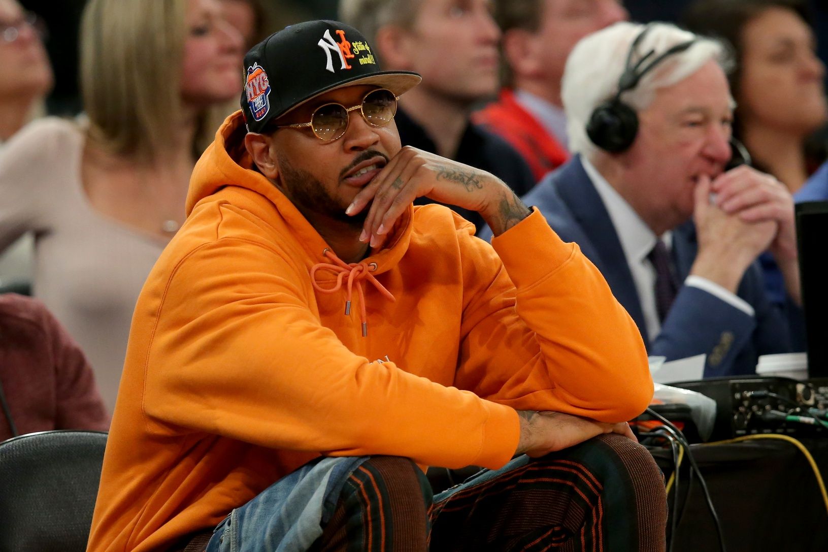 New York Knicks former player Carmelo Anthony sits courtside during the second half between the Villanova Wildcats and the Georgetown Hoyas at Madison Square Garden.