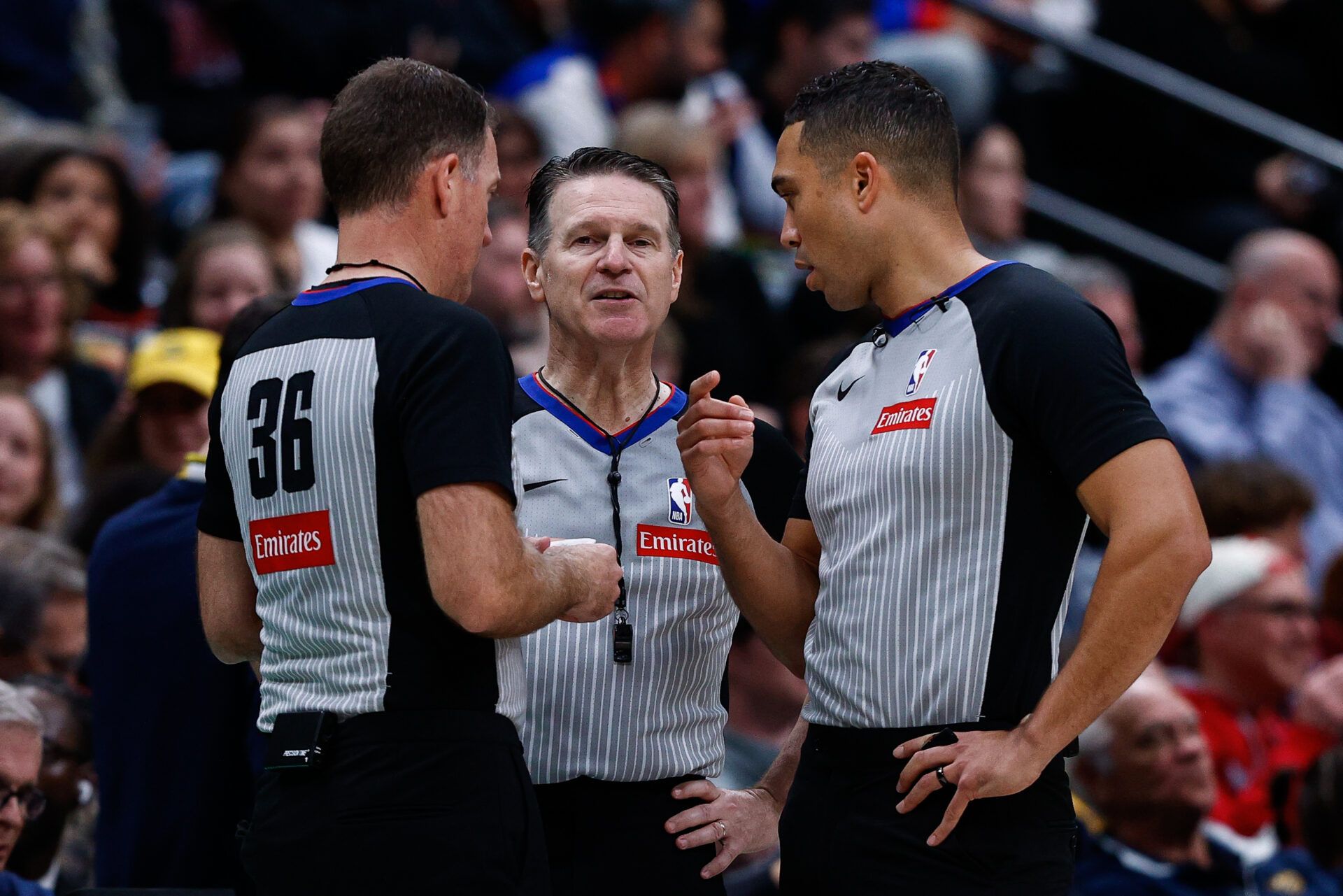 Referee Brent Barnaky (36) and referee Pat Fraher (26) and John Conley (56) talk after a play in the third quarter between the Denver Nuggets and the Chicago Bulls at Ball Arena.