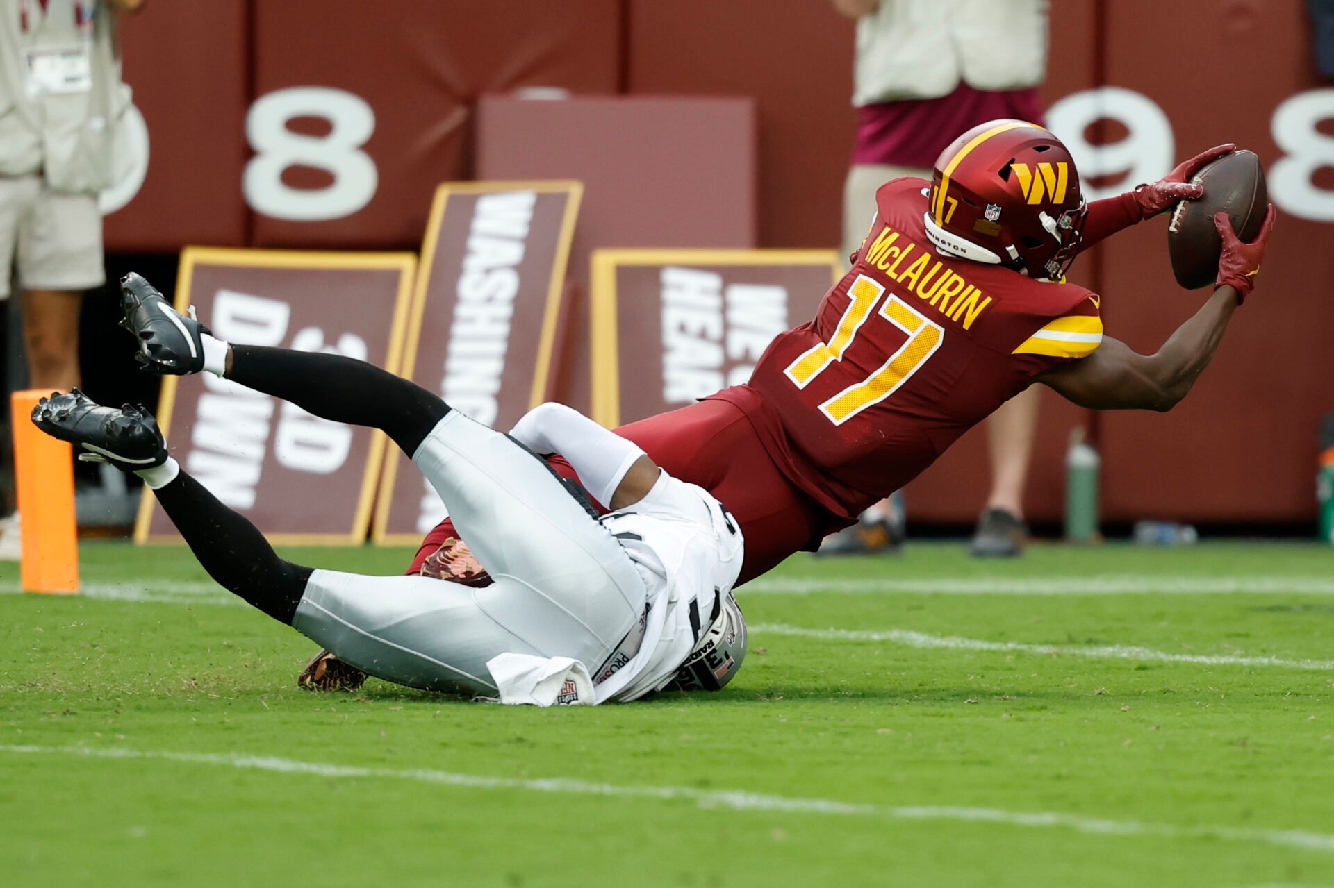 Washington Commanders wide receiver Terry McLaurin (17) dives for the end zone after making a catch as Las Vegas Raiders cornerback Kyu Blu Kelly (36) attempts a tackle during the third quarter at Northwest Stadium.