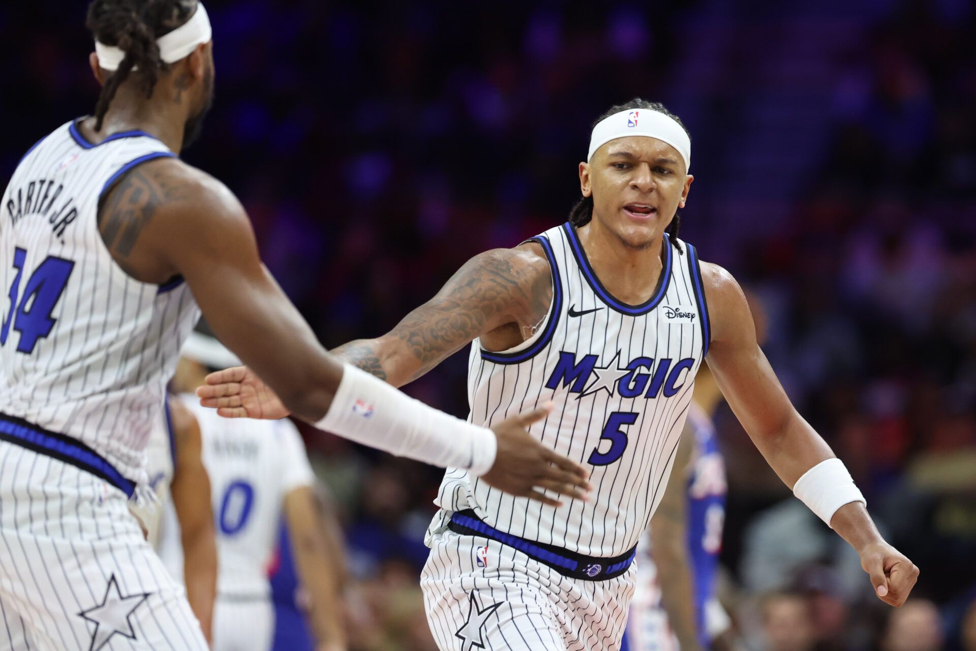 Orlando Magic forward Paolo Banchero (5) reacts with center Wendell Carter Jr. (34) after a score against the Philadelphia 76ers during the fourth quarter at Xfinity Mobile Arena.