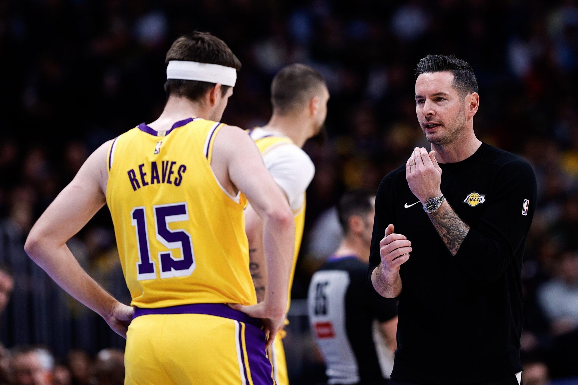 Los Angeles Lakers head coach JJ Redick talks with guard Austin Reaves (15) in the first quarter against the Denver Nuggets at Ball Arena.