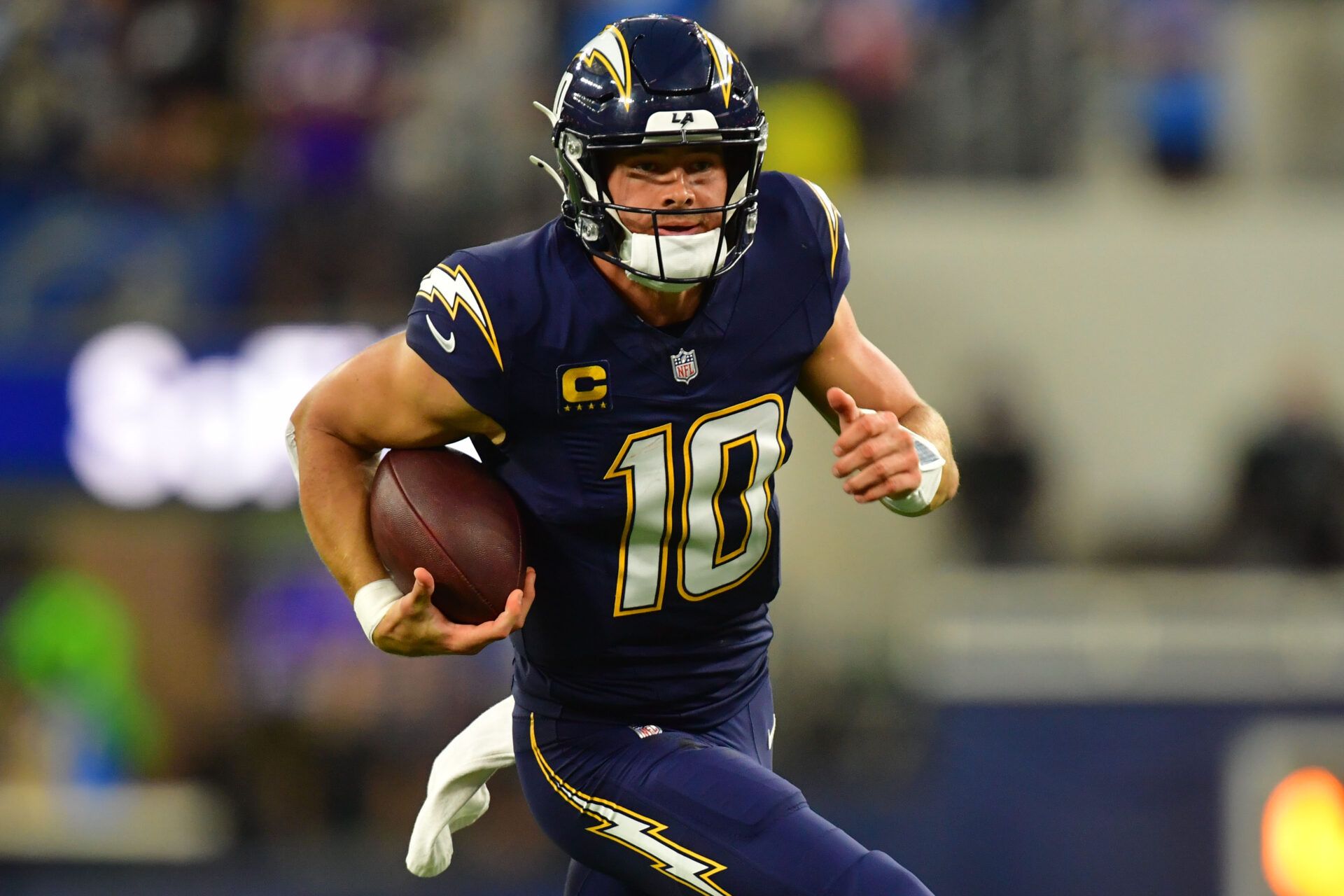 Los Angeles Chargers quarterback Justin Herbert (10) rushes the ball against the Minnesota Vikings during the first half at SoFi Stadium.