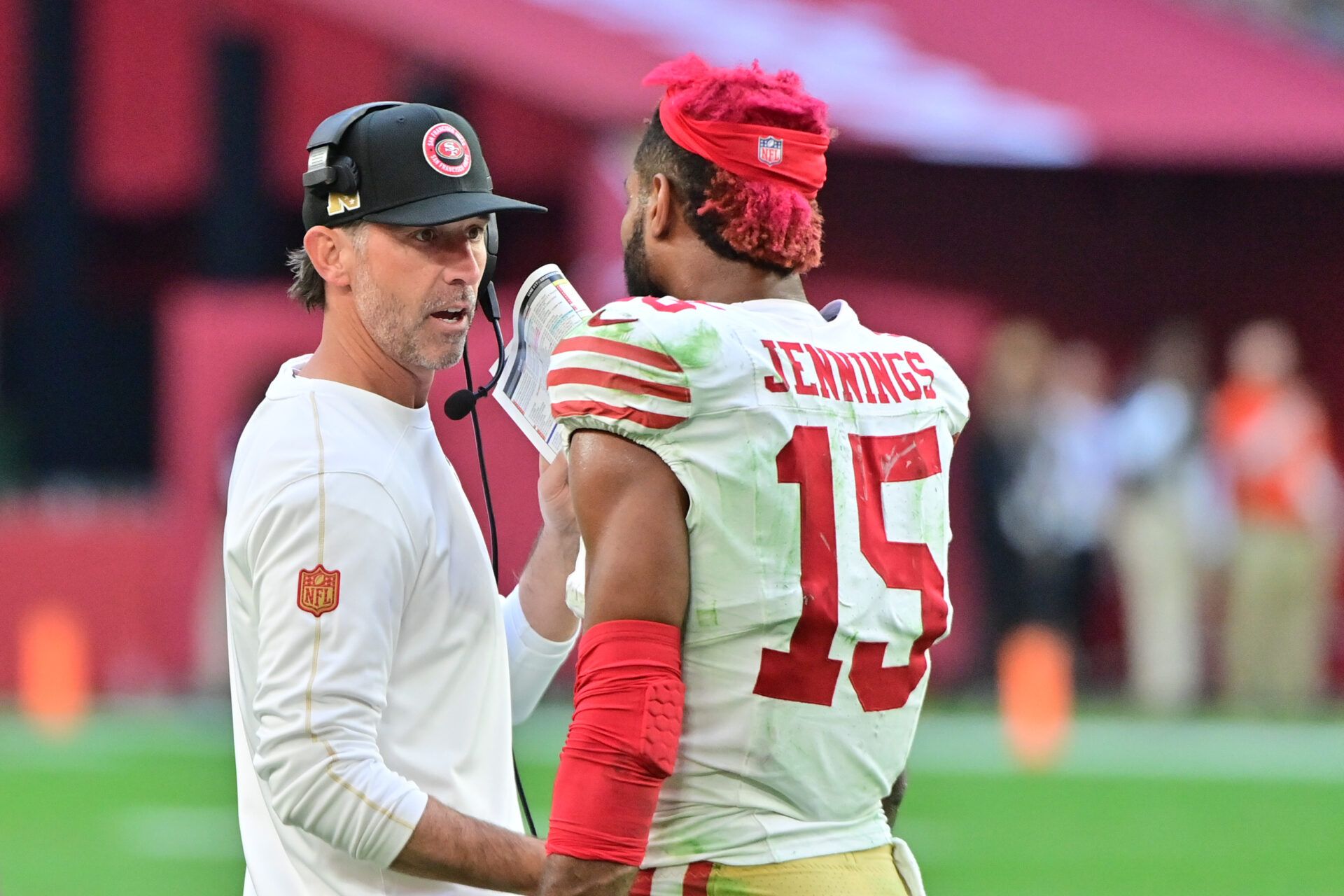 San Francisco 49ers wide receiver Jauan Jennings (15) talks with head coach Kyle Shanahan after being ejected in the first half against the Arizona Cardinals at State Farm Stadium.