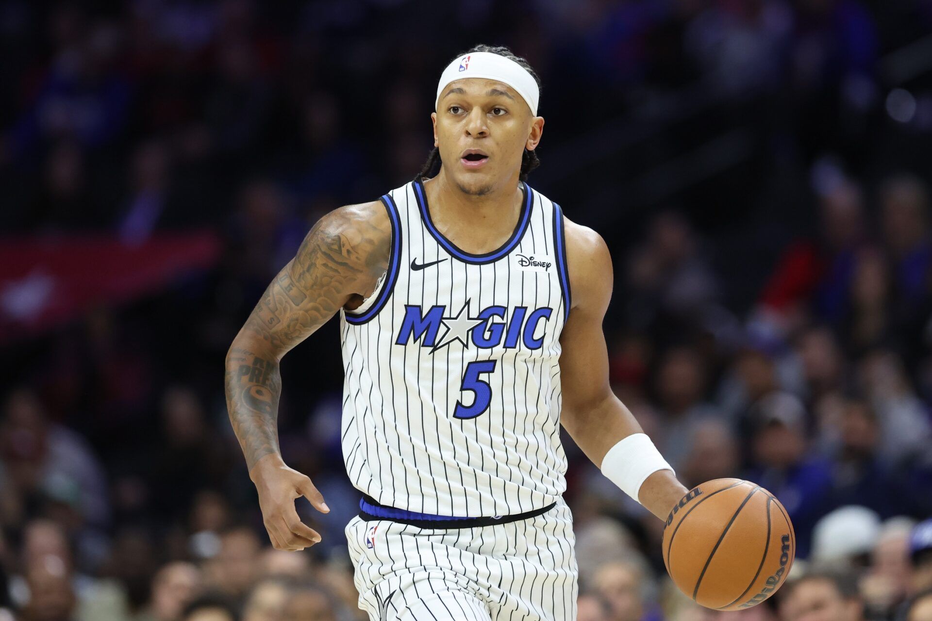 Orlando Magic forward Paolo Banchero (5) dribbles the ball against the Philadelphia 76ers during the first quarter at Xfinity Mobile Arena.