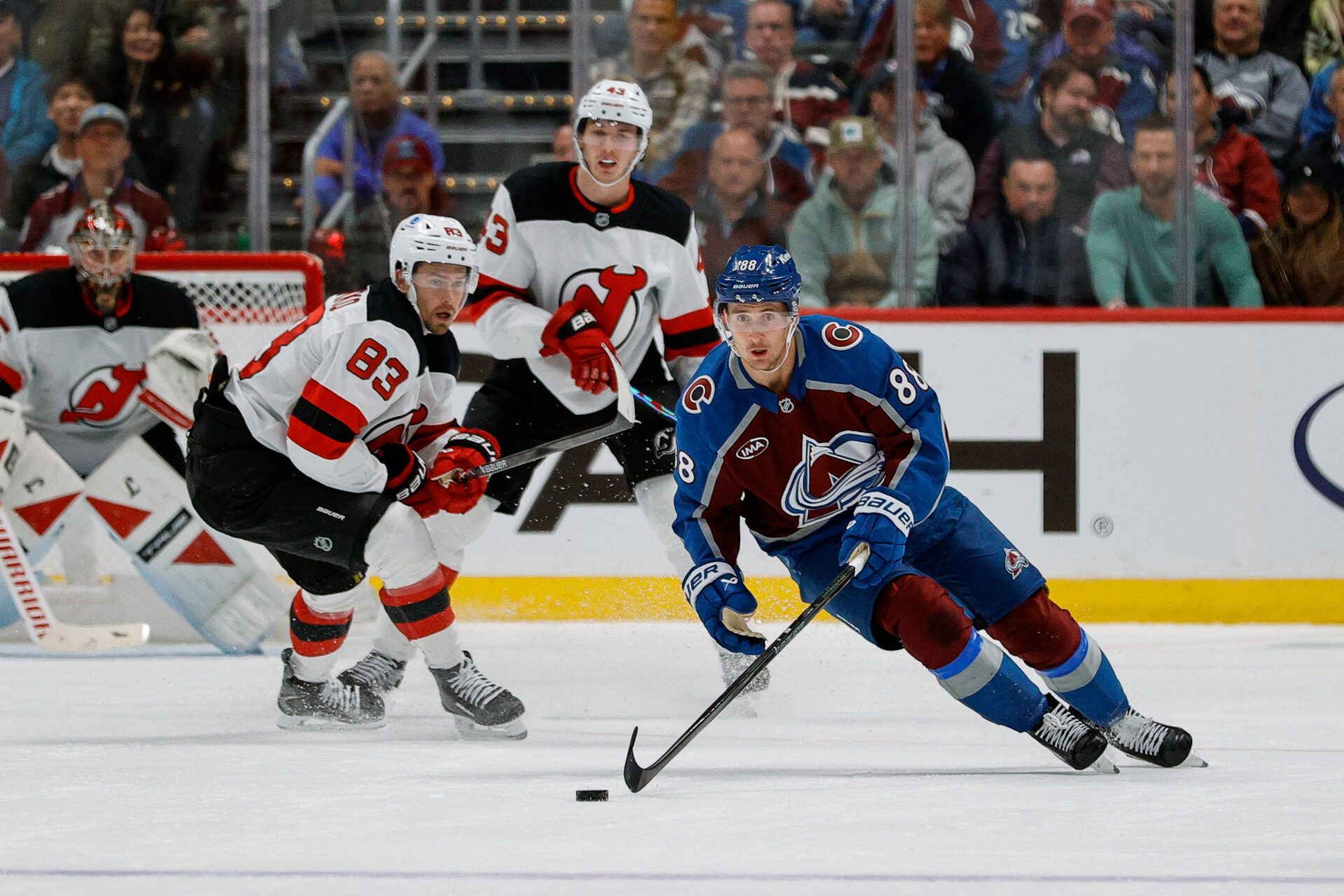 Colorado Avalanche center Martin Necas (88) controls the puck ahead of New Jersey Devils center Juho Lammikko (83) in the third period at Ball Arena.