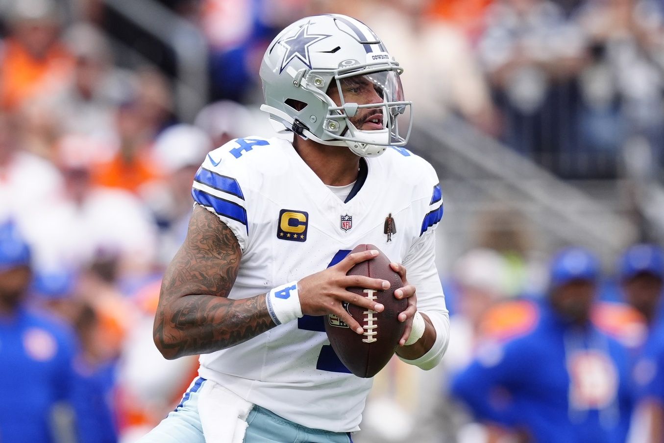 Dallas Cowboys quarterback Dak Prescott (4) looks to throw against the Denver Broncos in the first half at Empower Field at Mile High.