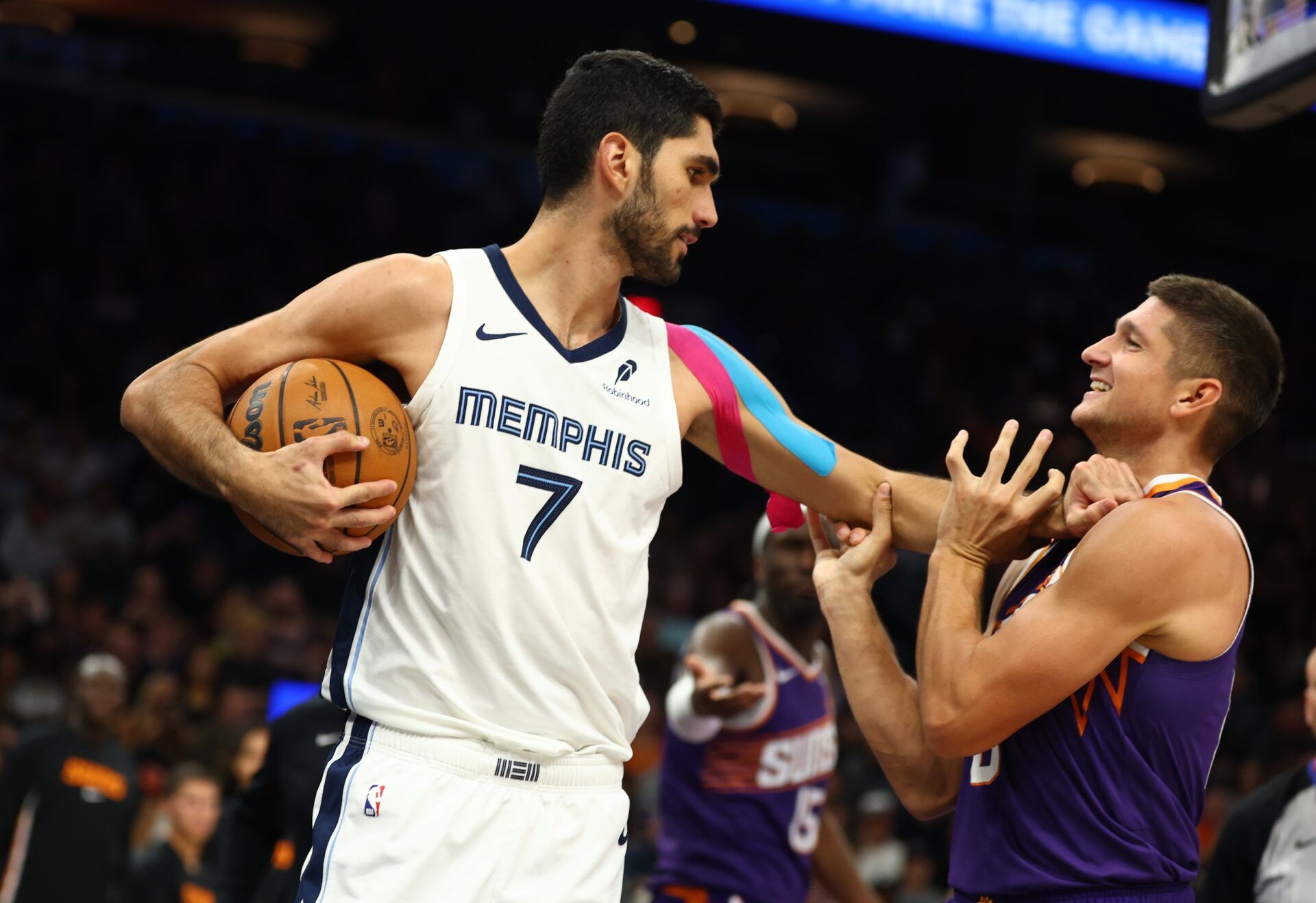 Memphis Grizzlies forward Santi Aldama (7) grabs Phoenix Suns guard Grayson Allen (8) during the second half at the Mortgage Matchup Center.