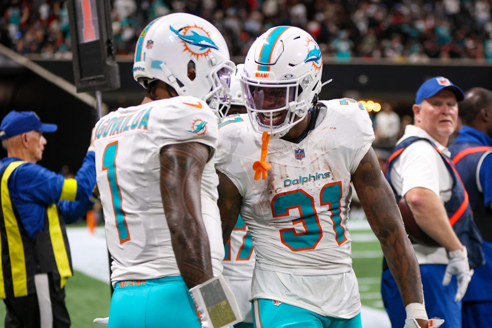 Miami Dolphins running back Ollie Gordon II (31) celebrates with quarterback Tua Tagovailoa (1) after a touchdown against the Atlanta Falcons in the fourth quarter at Mercedes-Benz Stadium.