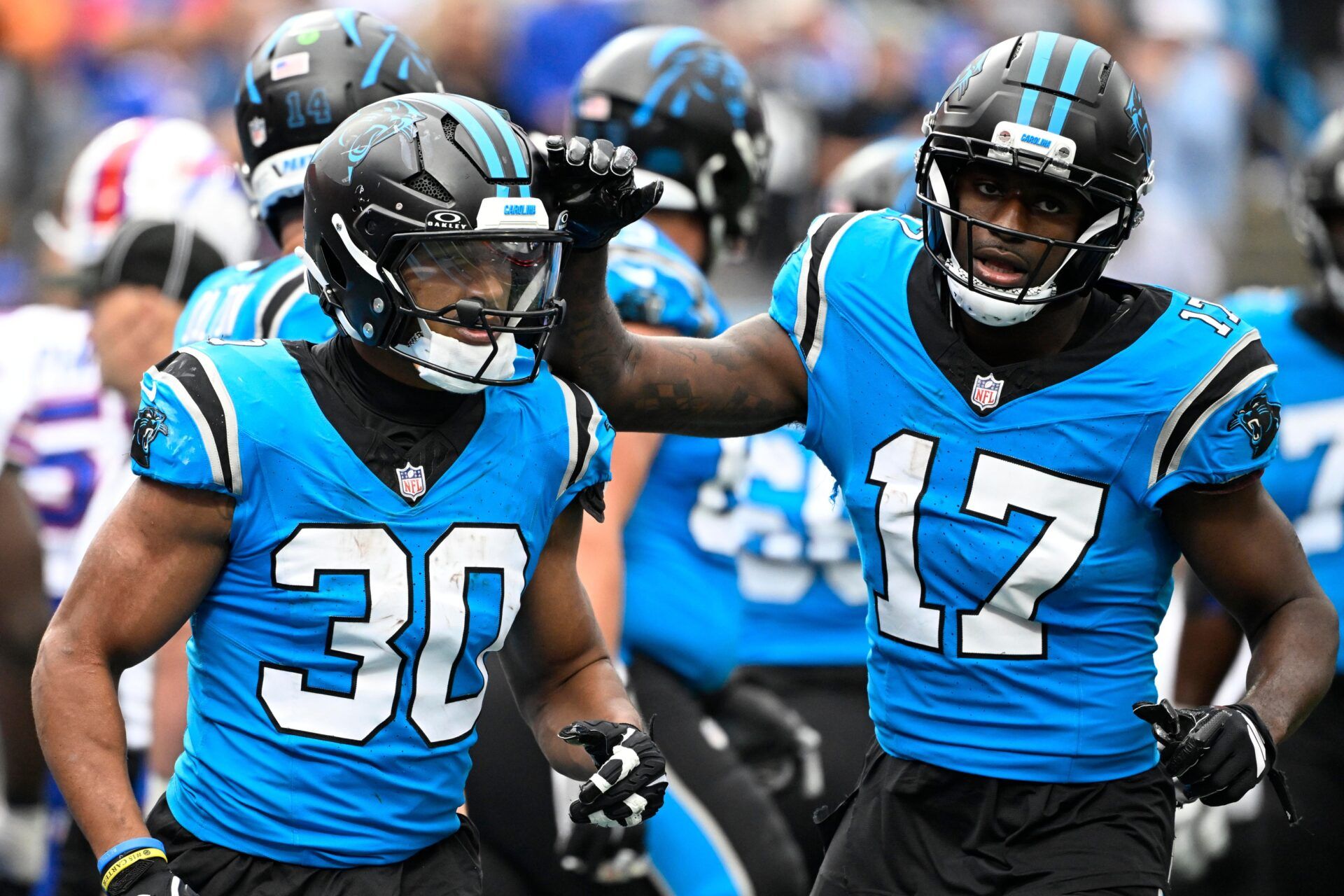 Carolina Panthers running back Chuba Hubbard (30) celebrates with wide receiver Xavier Legette (17) after scoring a touchdown in the fourth quarter against the Buffalo Bills at Bank of America Stadium.