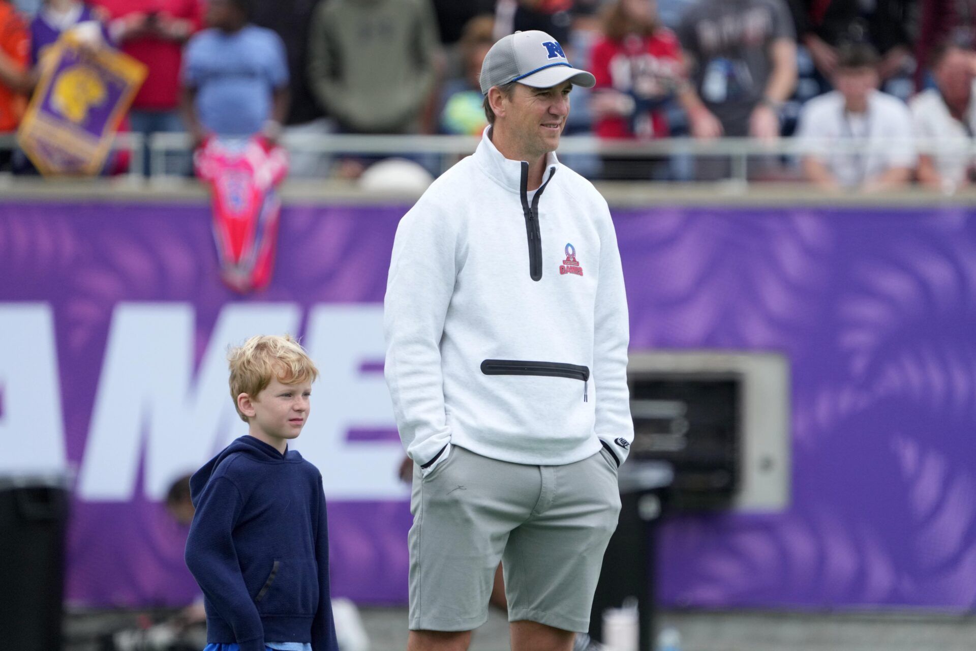 NFC coach Eli Manning with son Charlie Manning during Pro Bowl Games practice at Camping World Stadium.
