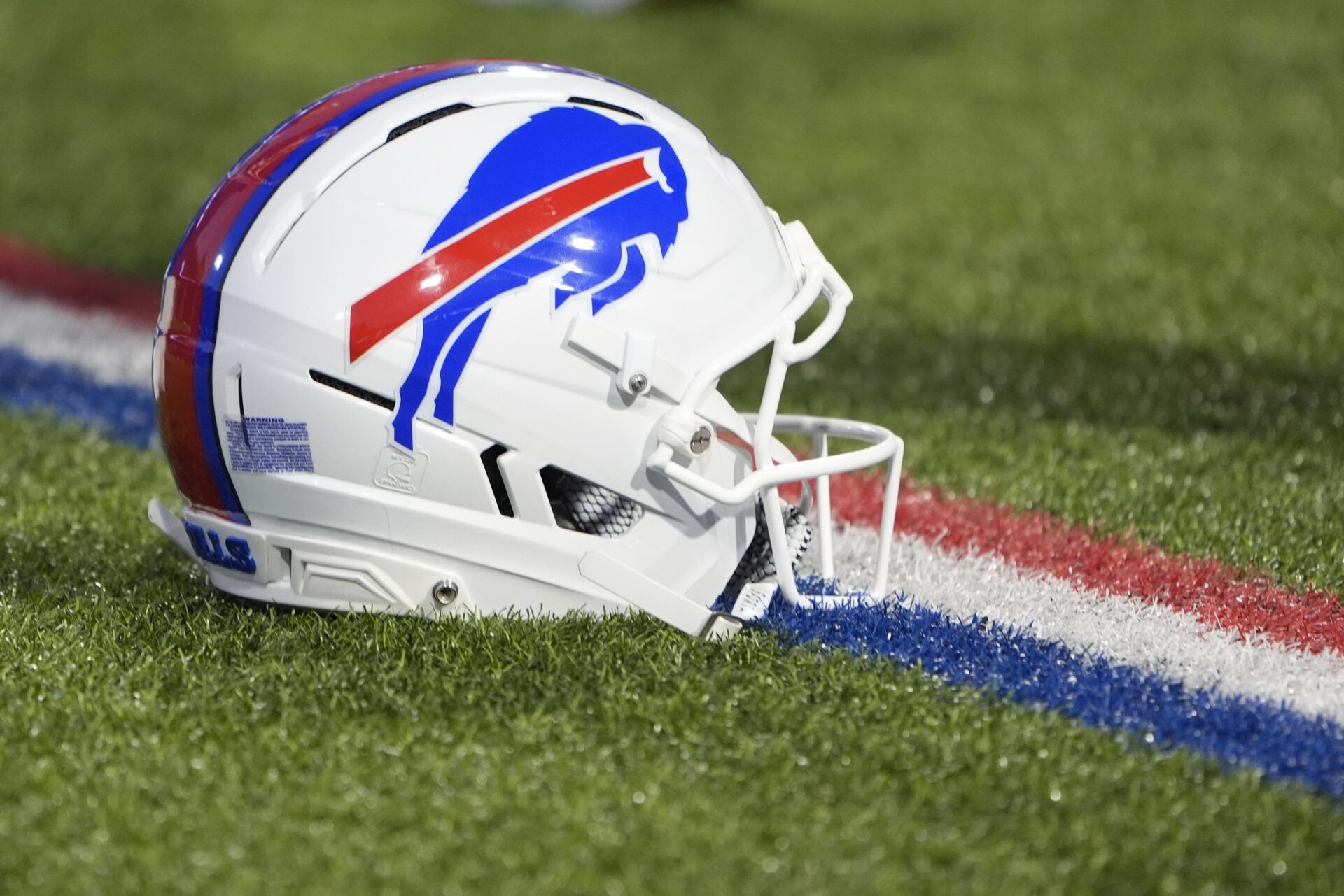 Detailed view of Buffalo Bills helmet on the field prior to the first quarter against the Baltimore Ravens at Highmark Stadium.