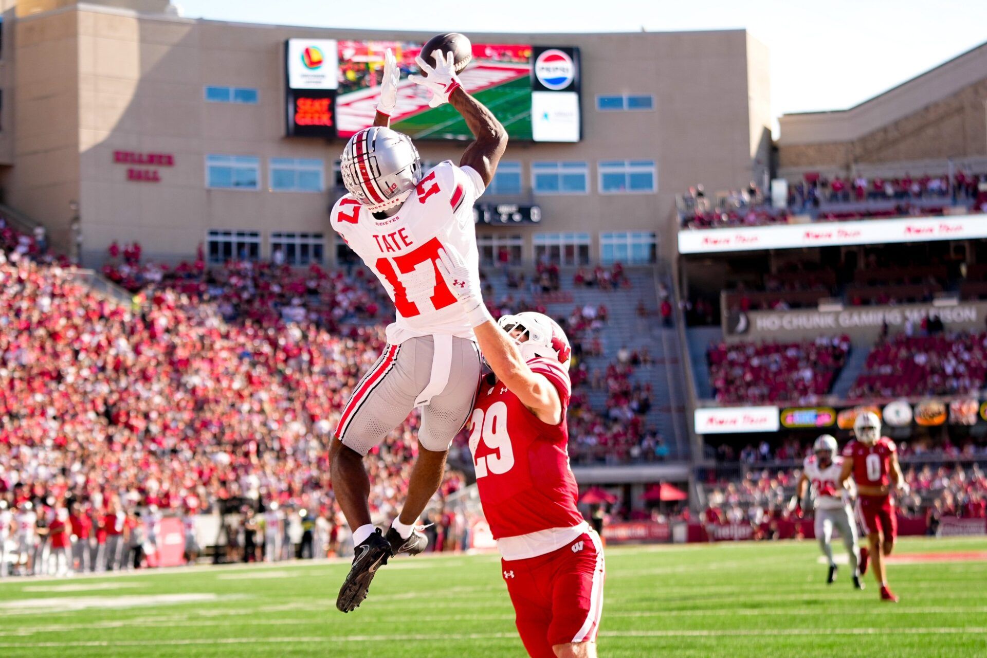 Ohio State Buckeyes wide receiver Carnell Tate (17) catches a touchdown pass against Wisconsin Badgers safety Matt Jung (29) in the first half at Camp Randall Stadium on Saturday, Oct. 18, 2025 in Madison, Wisconsin.