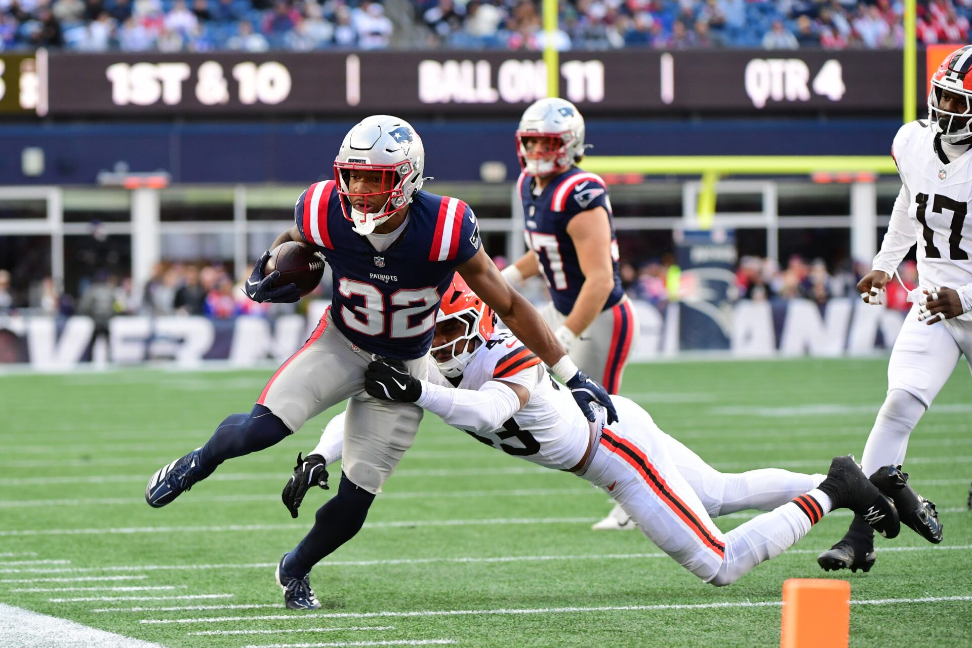 Cleveland Browns linebacker Mohamoud Diabate (43) tackesl New England Patriots running back Treveyon Henderson (32) during the fourth quarter at Gillette Stadium.