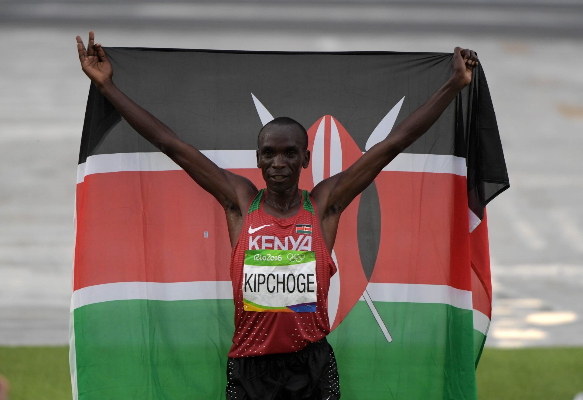 Eliud Kipchoge (KEN) poses with Kenyan flag after winning the marathon in 2:08:44 in the marathon during the Rio 2016 Summer Olympic Games at Sambodromo.
