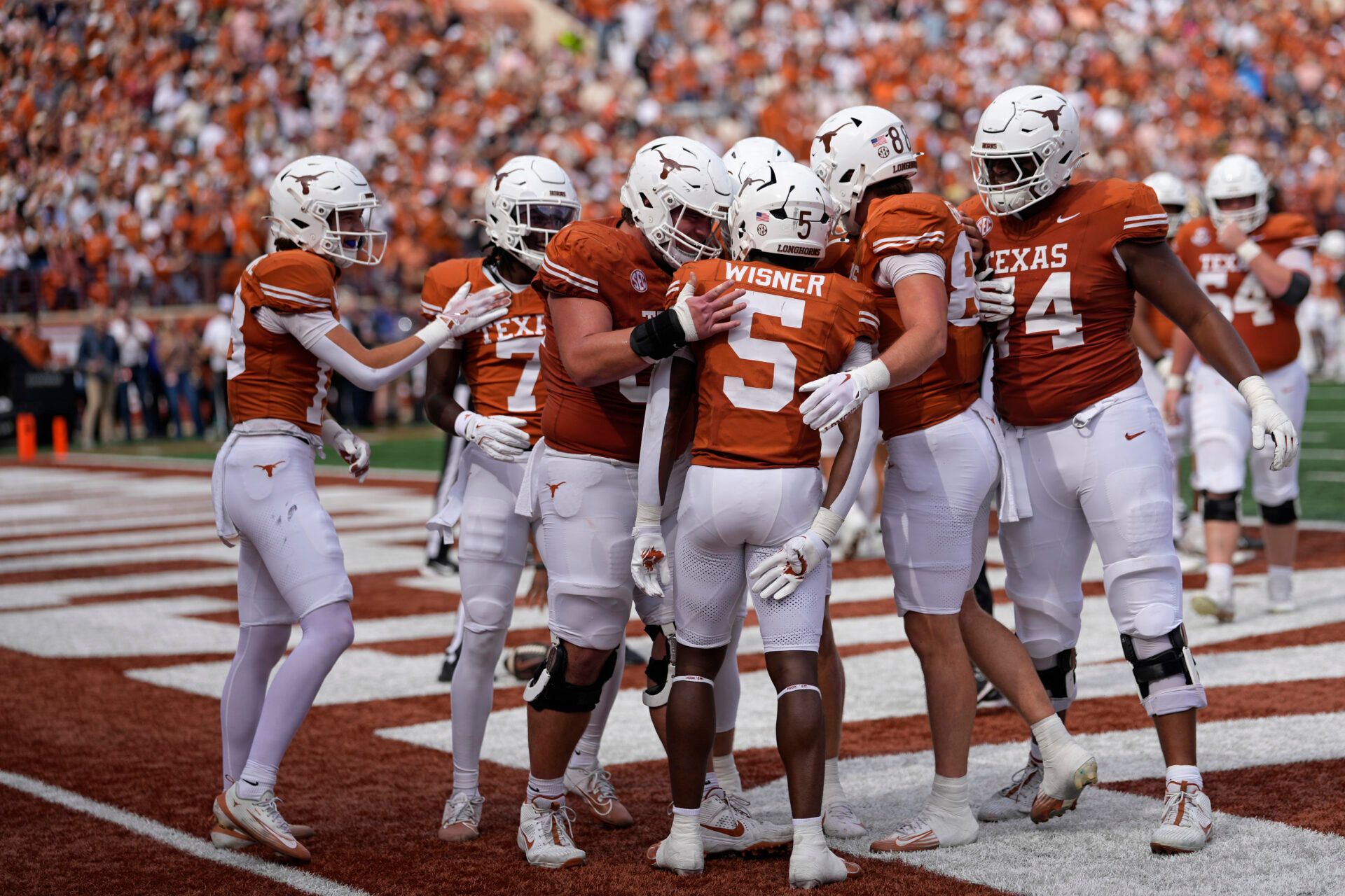 Texas Longhorns celebrate after running back Quintrevion Wisner (5) runs for a touchdown in the first half against the Vanderbilt Commodores at Darrell K Royal-Texas Memorial Stadium.