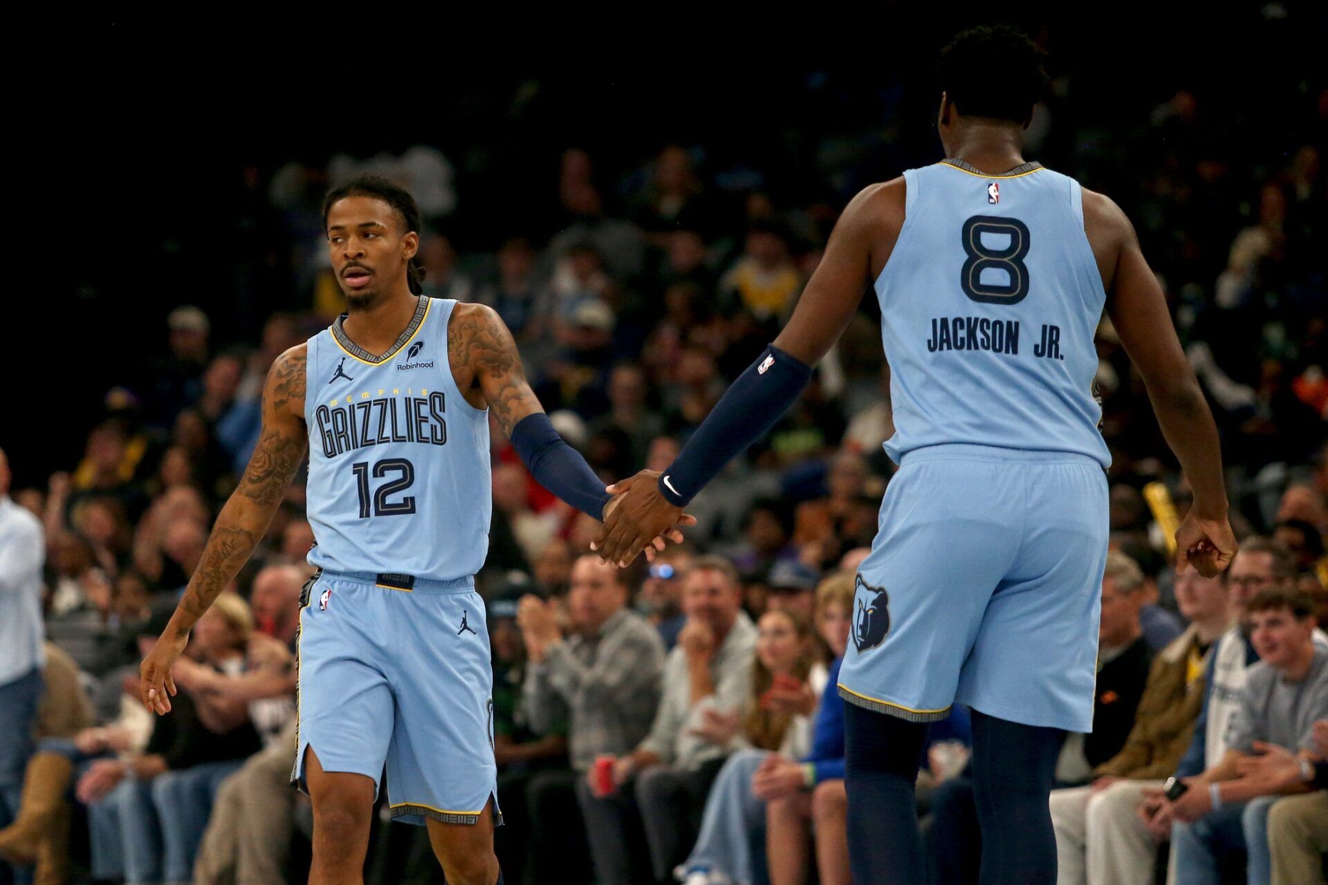 Memphis Grizzlies guard Ja Morant (12) reacts with forward/center Jaren Jackson Jr. (8) during the first quarter against the Los Angeles Lakers at FedExForum.