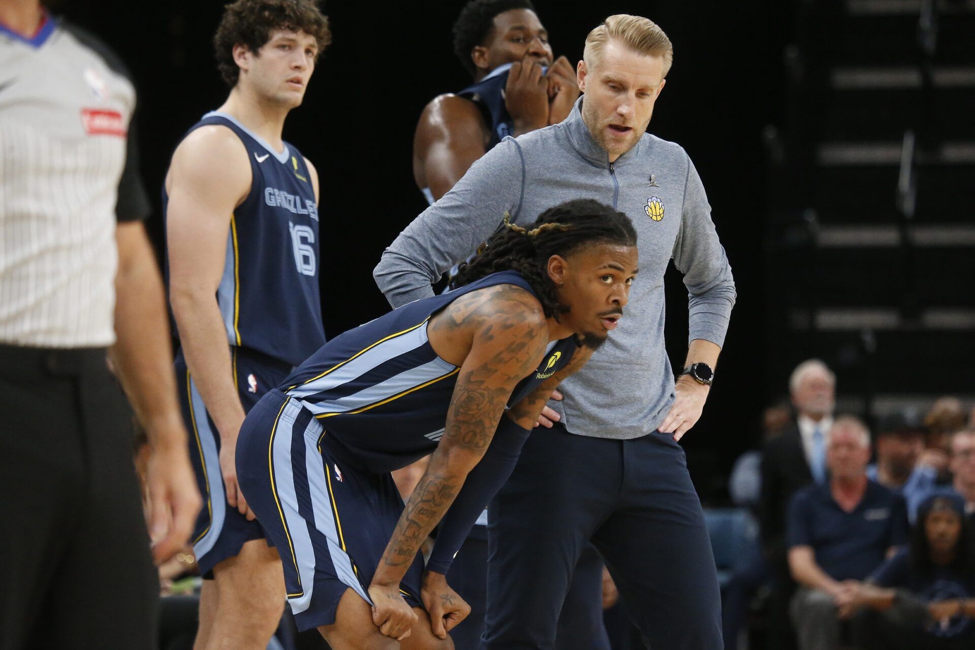 Memphis Grizzlies head coach Tuomas Iisalo talks with guard Ja Morant (12) during the first quarter against the Miami Heat at FedExForum.