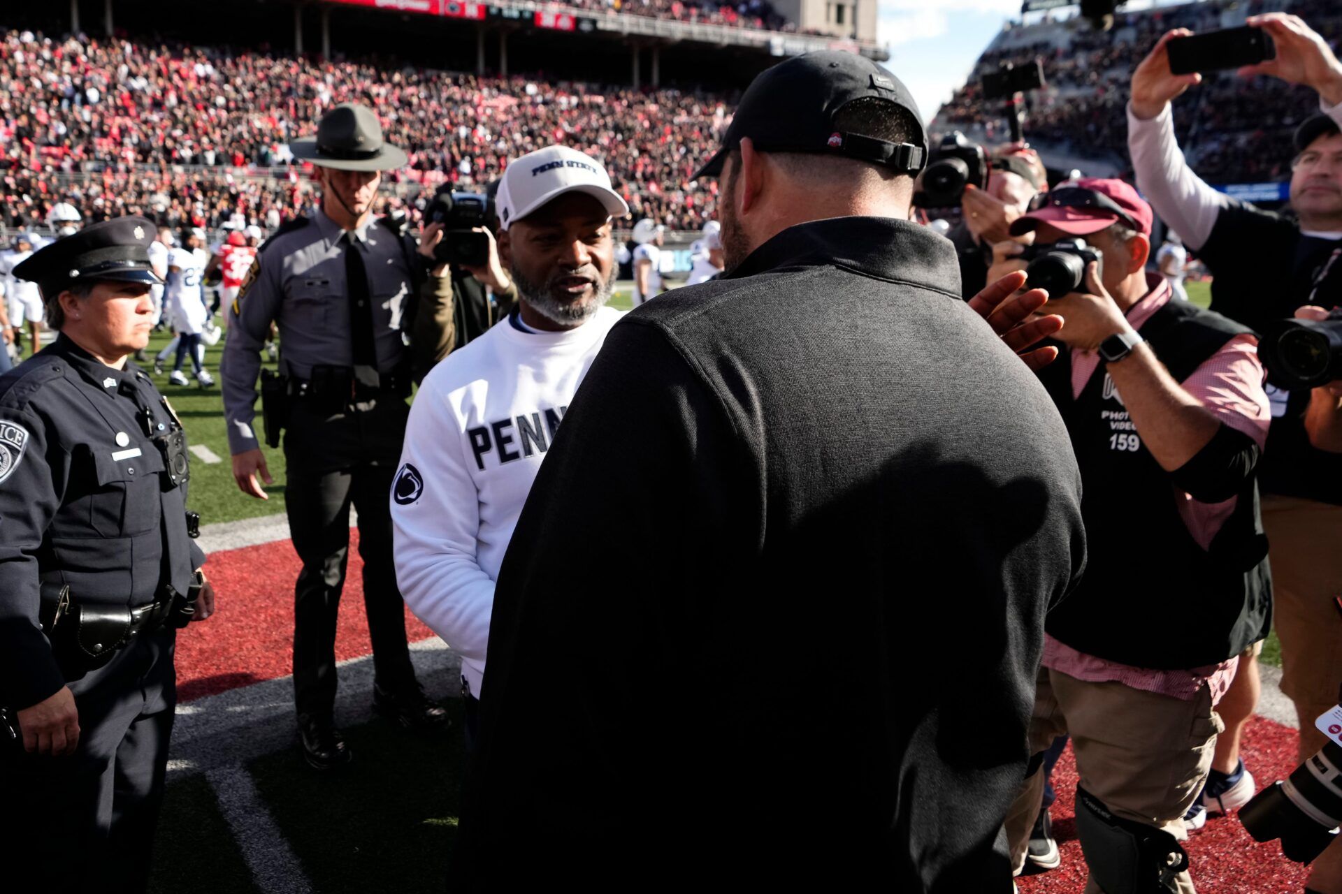 Ohio State Buckeyes head coach Ryan Day shakes hands with Penn State Nittany Lions interim head coach Terry Smith following the NCAA football game at Ohio Stadium in Columbus on Nov. 1, 2025.