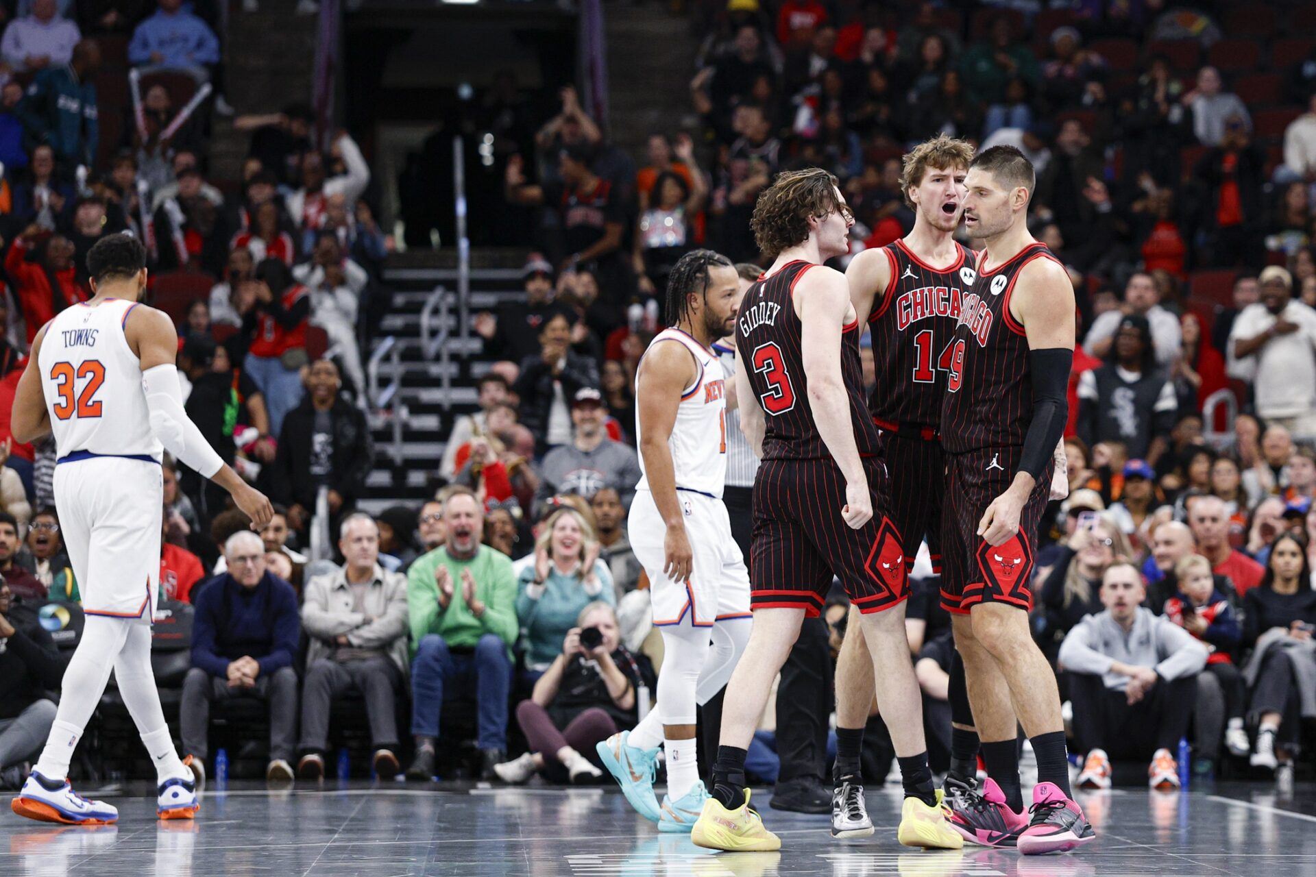 Chicago Bulls guard Josh Giddey (3), forward Matas Buzelis (14) and center Nikola Vucevic (9) celebrate during the second half of an NBA game against the New York Knicks at United Center.