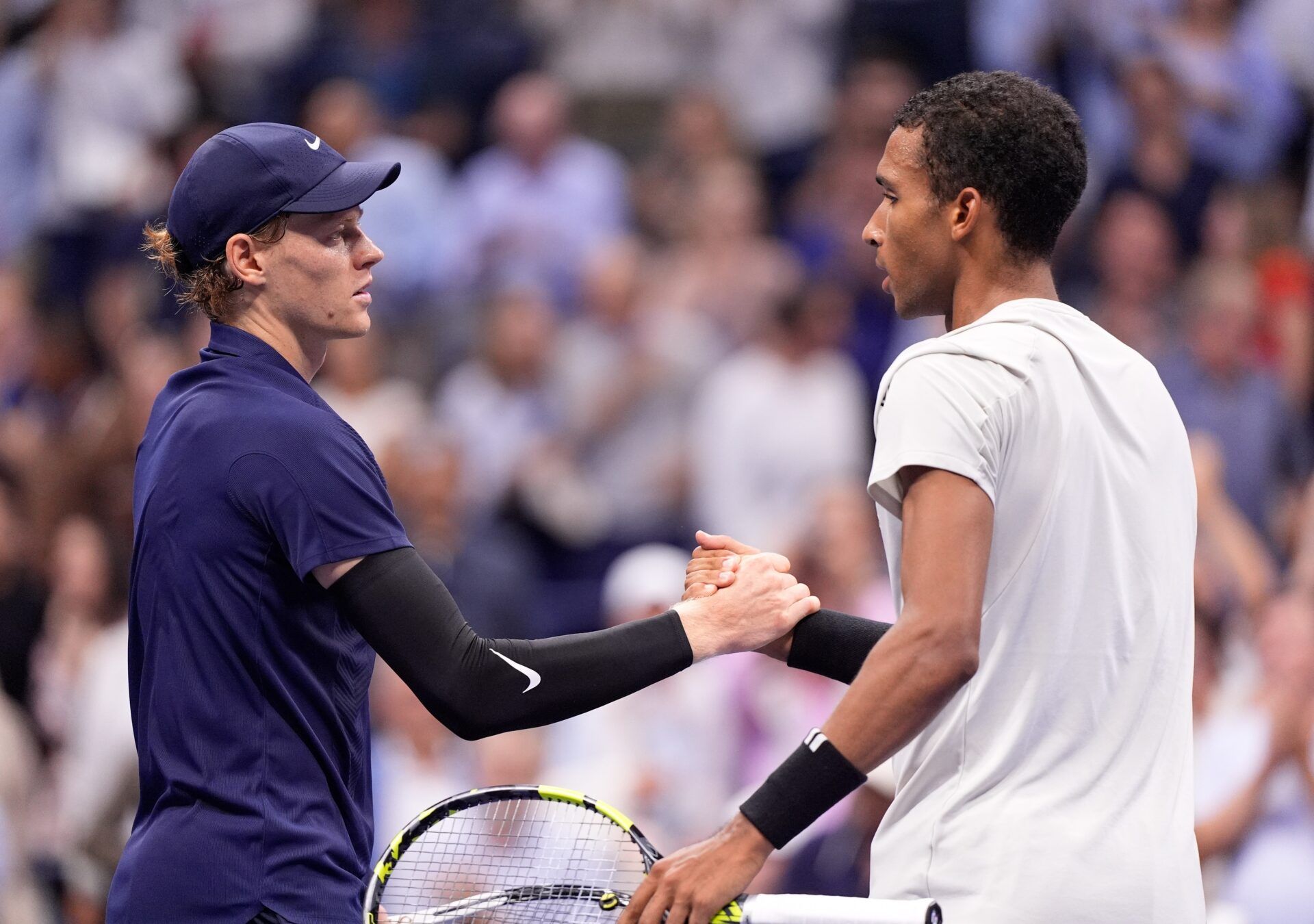 Jannik Sinner (left) (ITA) after beating Felix Auger-Aliassime (CAN) (right) on day thirteen of the 2025 U.S. Open tennis tournament at the USTA Billie Jean King National Tennis Center.