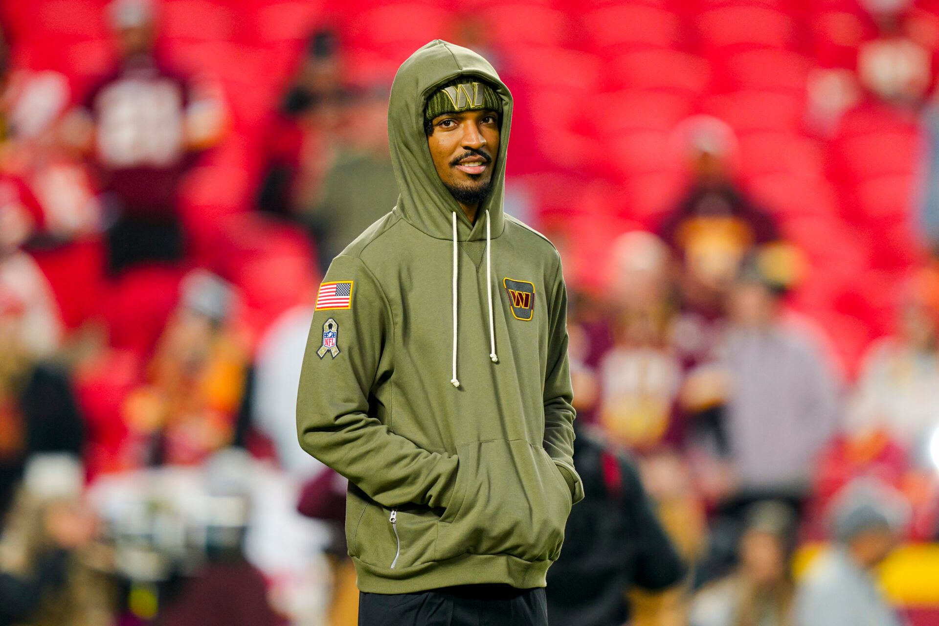 Washington Commanders quarterback Jayden Daniels (5) looks on during warmups prior to a game against the Kansas City Chiefs at GEHA Field at Arrowhead Stadium.