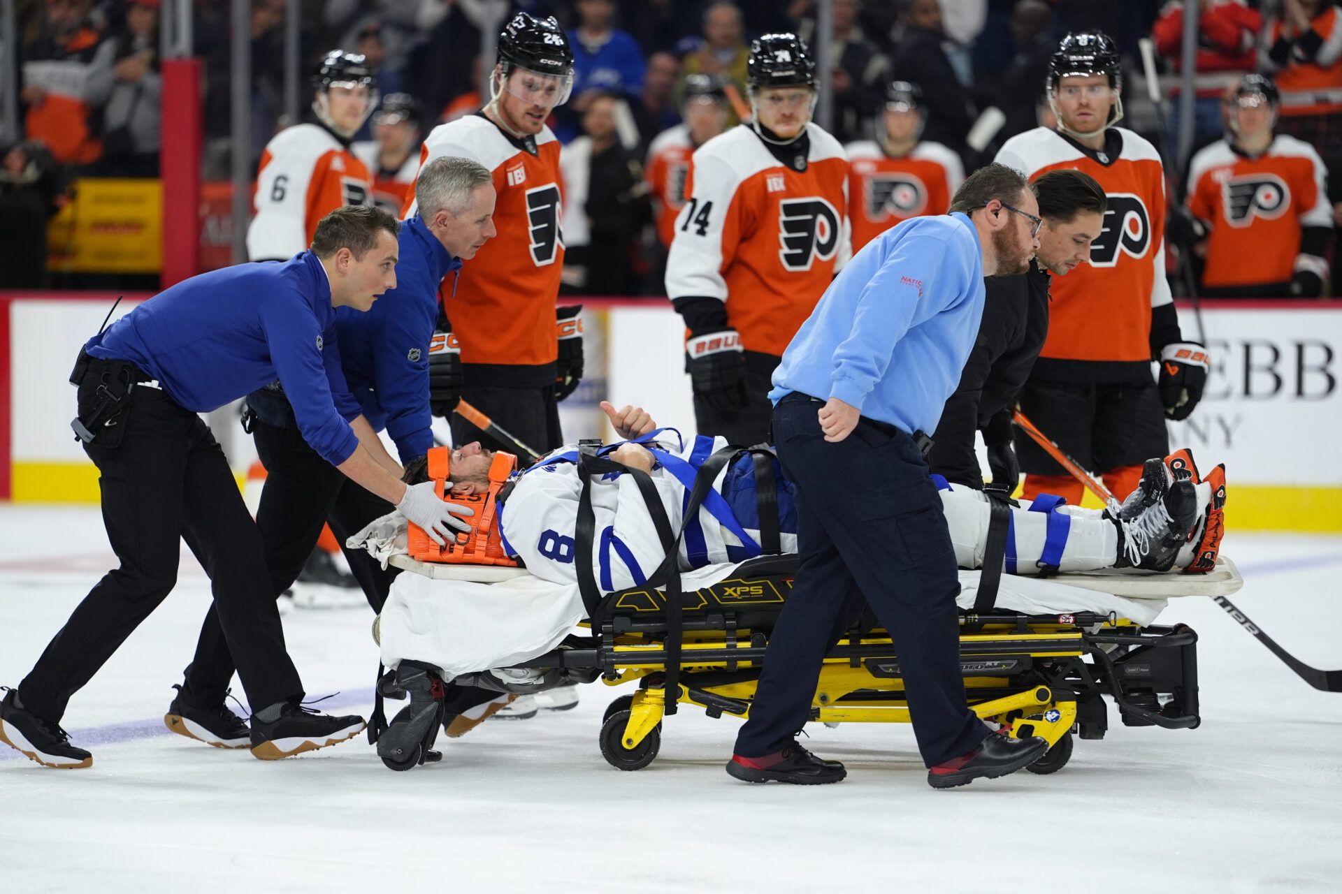 Toronto Maple Leafs defenseman Chris Tanev (8) reacts as he is assisted off the ice after an injury against the Philadelphia Flyers in the third period at Xfinity Mobile Arena.