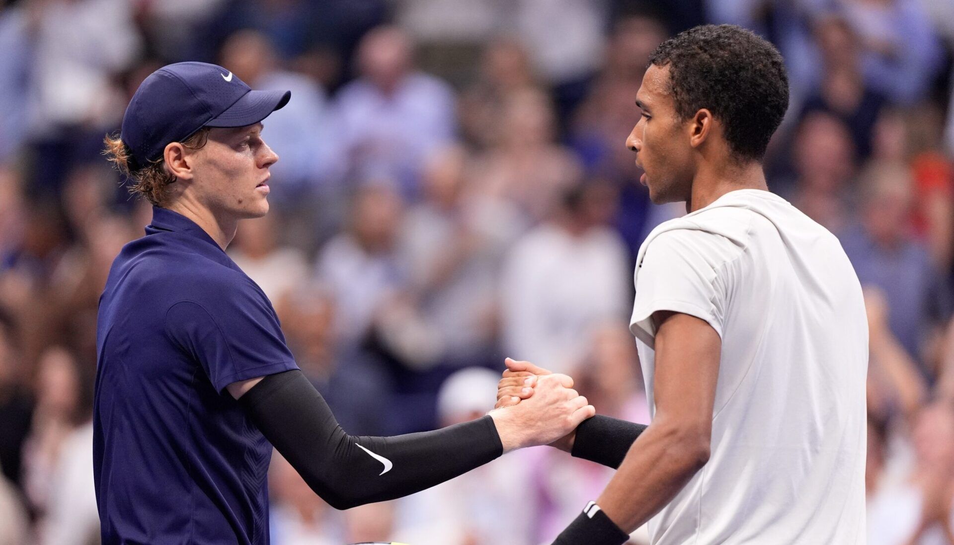 Flushing, NY, USA;  Jannik Sinner (left) (ITA) after beating Felix Auger-Aliassime (CAN) (right) on day thirteen of the 2025 U.S. Open tennis tournament at the USTA Billie Jean King National Tennis Center.