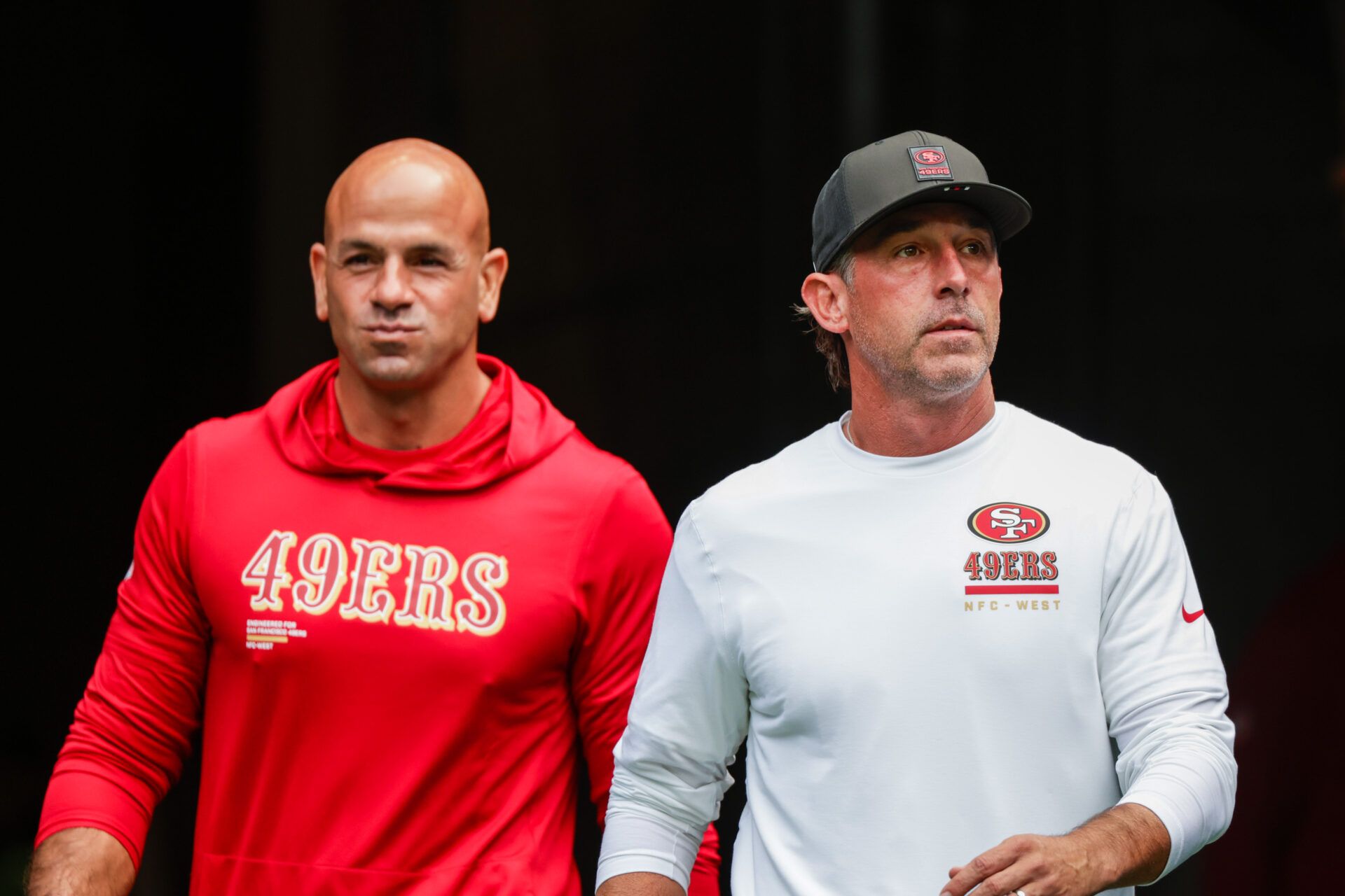 San Francisco 49ers defensive coordinator Robert Saleh, left, and head coach Kyle Shanahan, right, exit the locker room during pregame warmups against the Seattle Seahawks at Lumen Field.