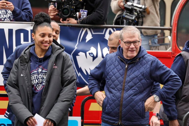 UConn Huskies head coach Geno Auriemma and UConn student-athlete Azzi Fudd smile at the crowd during the Final Four champions victory parade and rally outside of the XL Center in Hartford, CT.