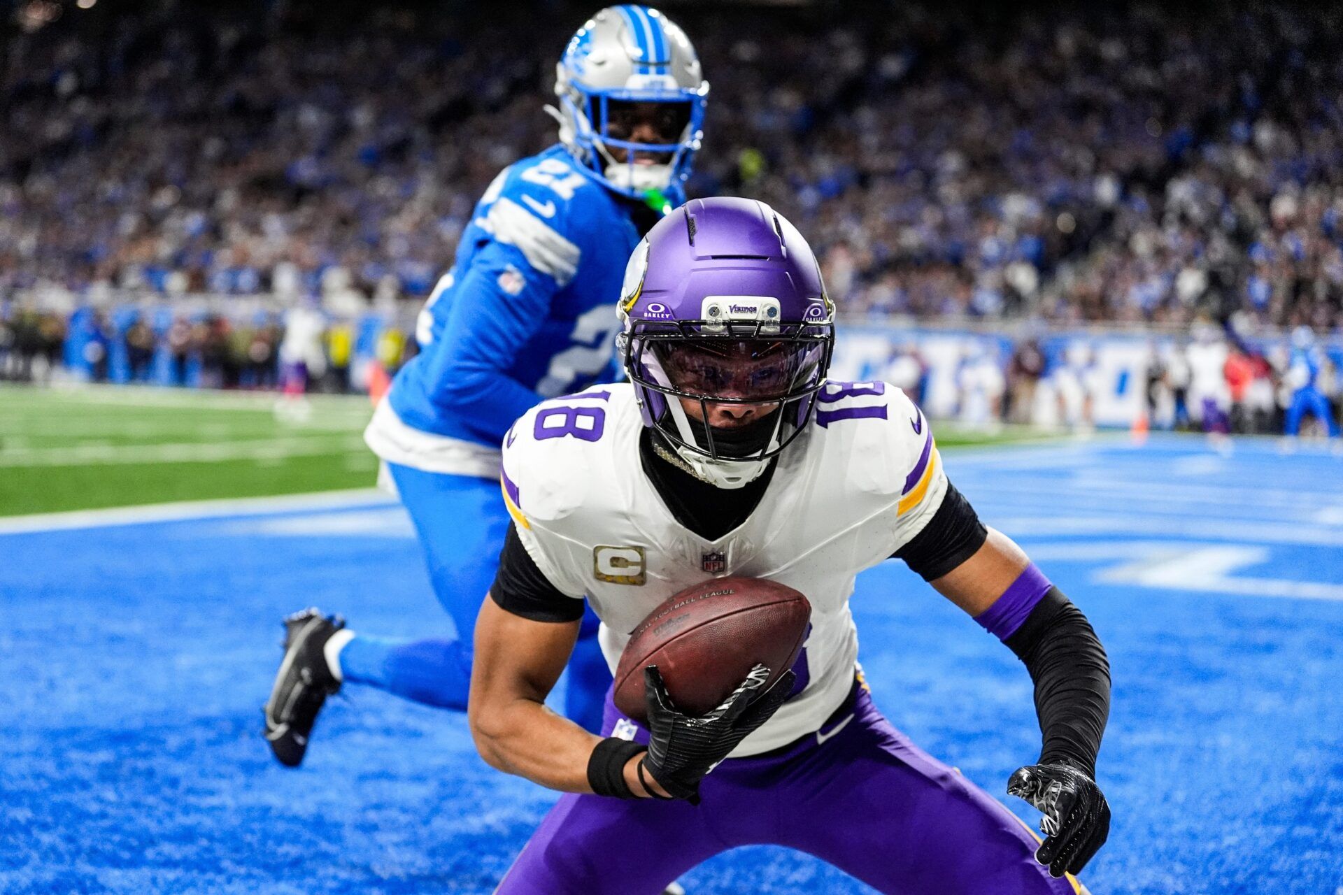 Minnesota Vikings wide receiver Justin Jefferson (18) makes a catch for a touchdown against Detroit Lions cornerback Amik Robertson (21) during the first half at Ford Field in Detroit on Sunday, November 2, 2025.