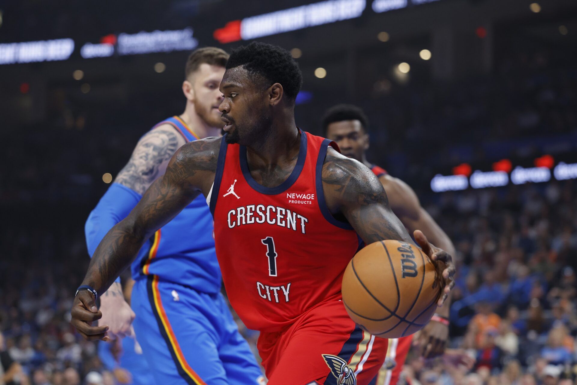 New Orleans Pelicans forward Zion Williamson (1) moves the ball around Oklahoma City Thunder center Isaiah Hartenstein (55) after a rebound during the first quarter at Paycom Center.