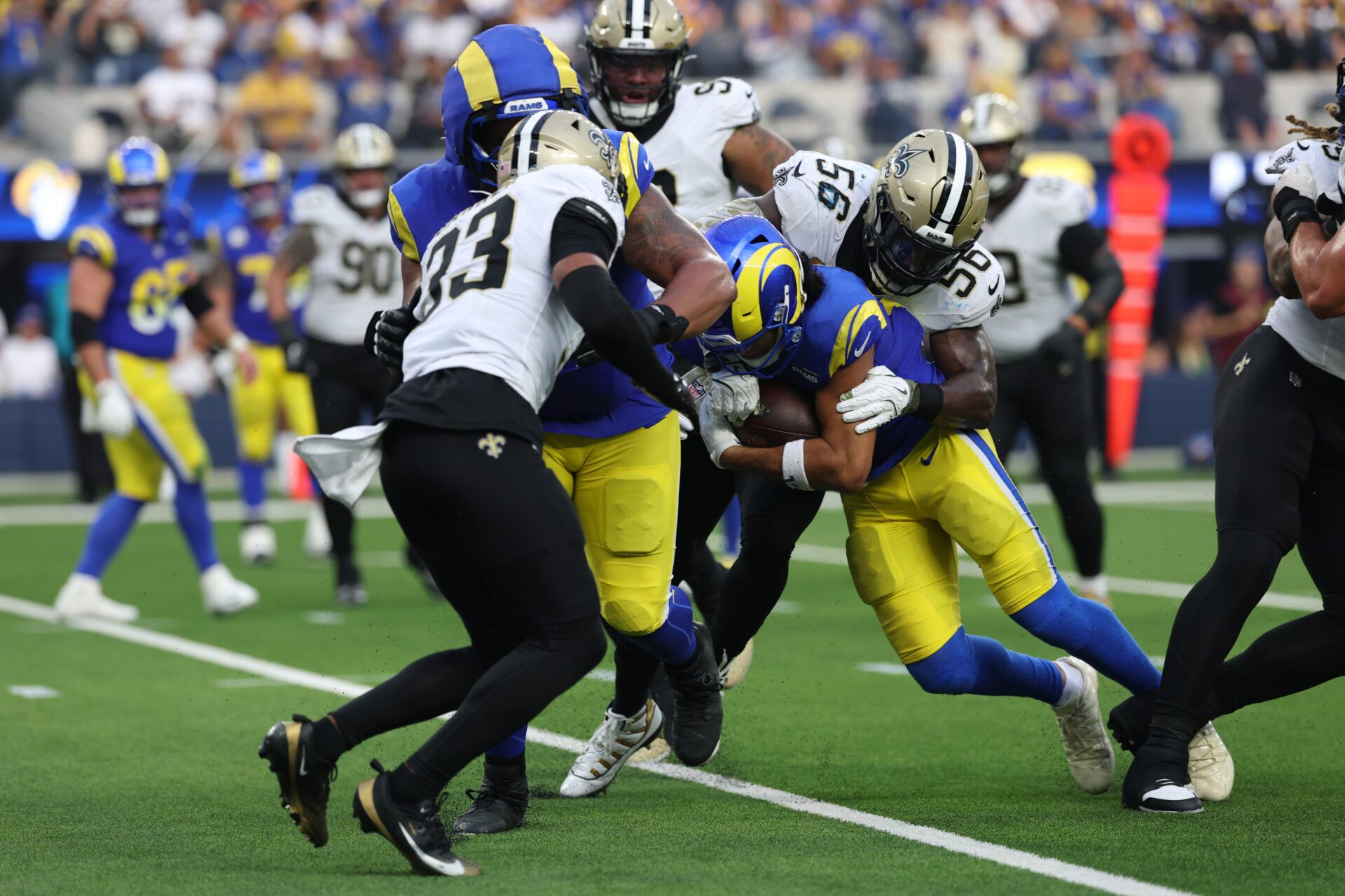 Los Angeles Rams wide receiver Puka Nacua (12) is tackled by. New Orleans Saints linebacker Demario Davis (56) during the second half at SoFi Stadium.