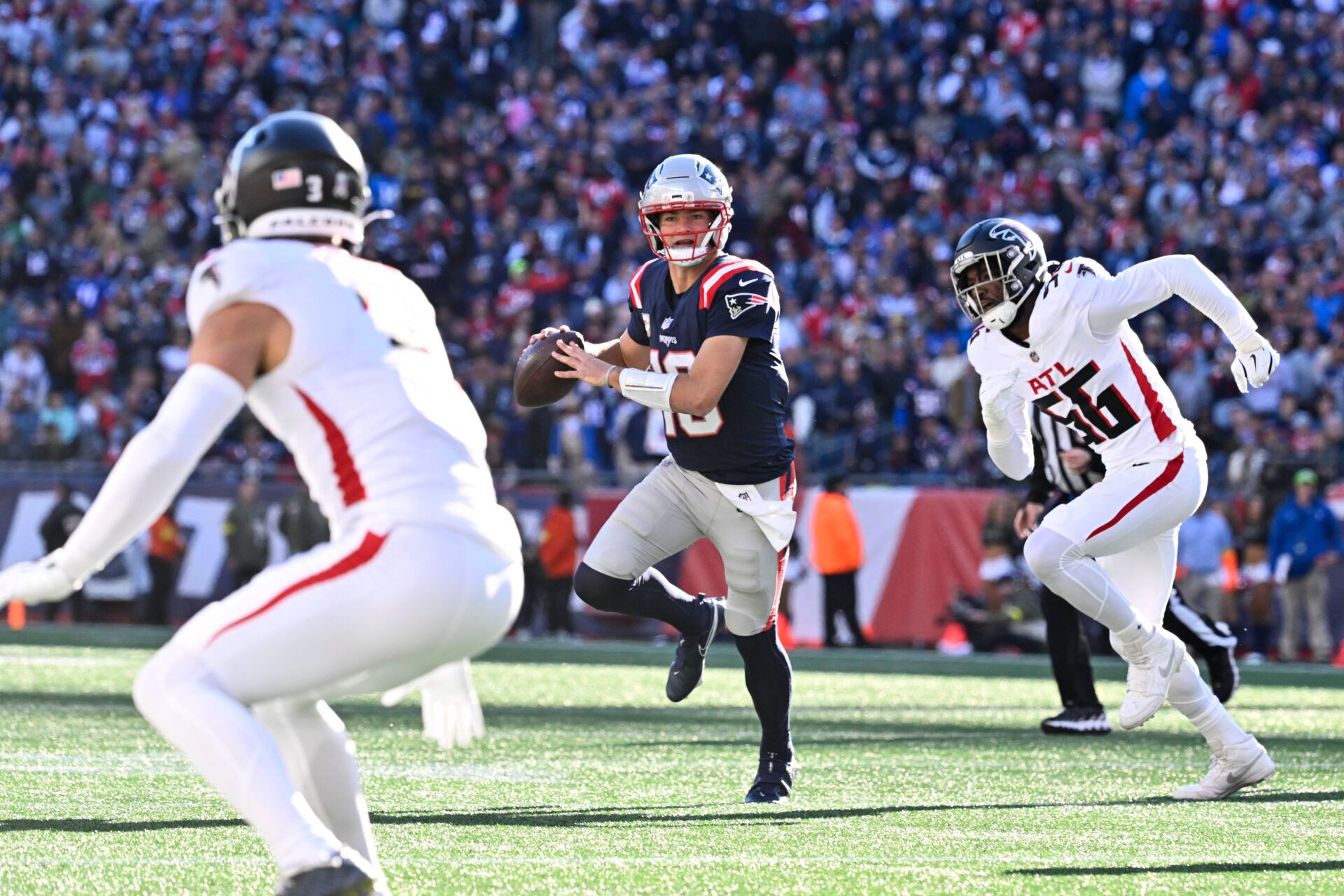 New England Patriots quarterback Drake Maye (10) runs the ball against Atlanta Falcons defensive end Leonard Floyd (56) during the first half at Gillette Stadium.