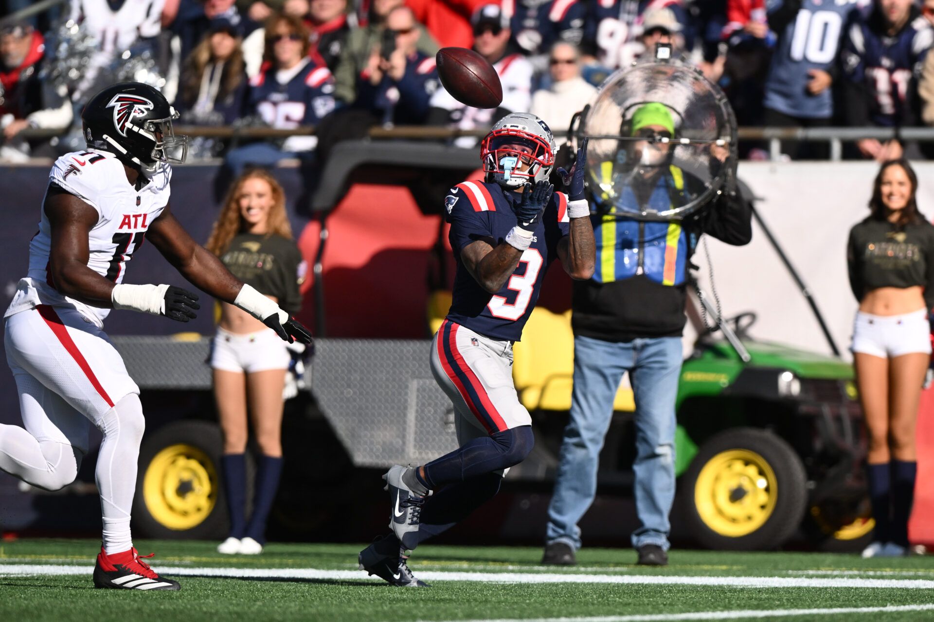 New England Patriots wide receiver DeMario Douglas (3) catches for a touchdown agaisnt Atlanta Falcons linebacker Jalon Walker (11) during the first quarter at Gillette Stadium.