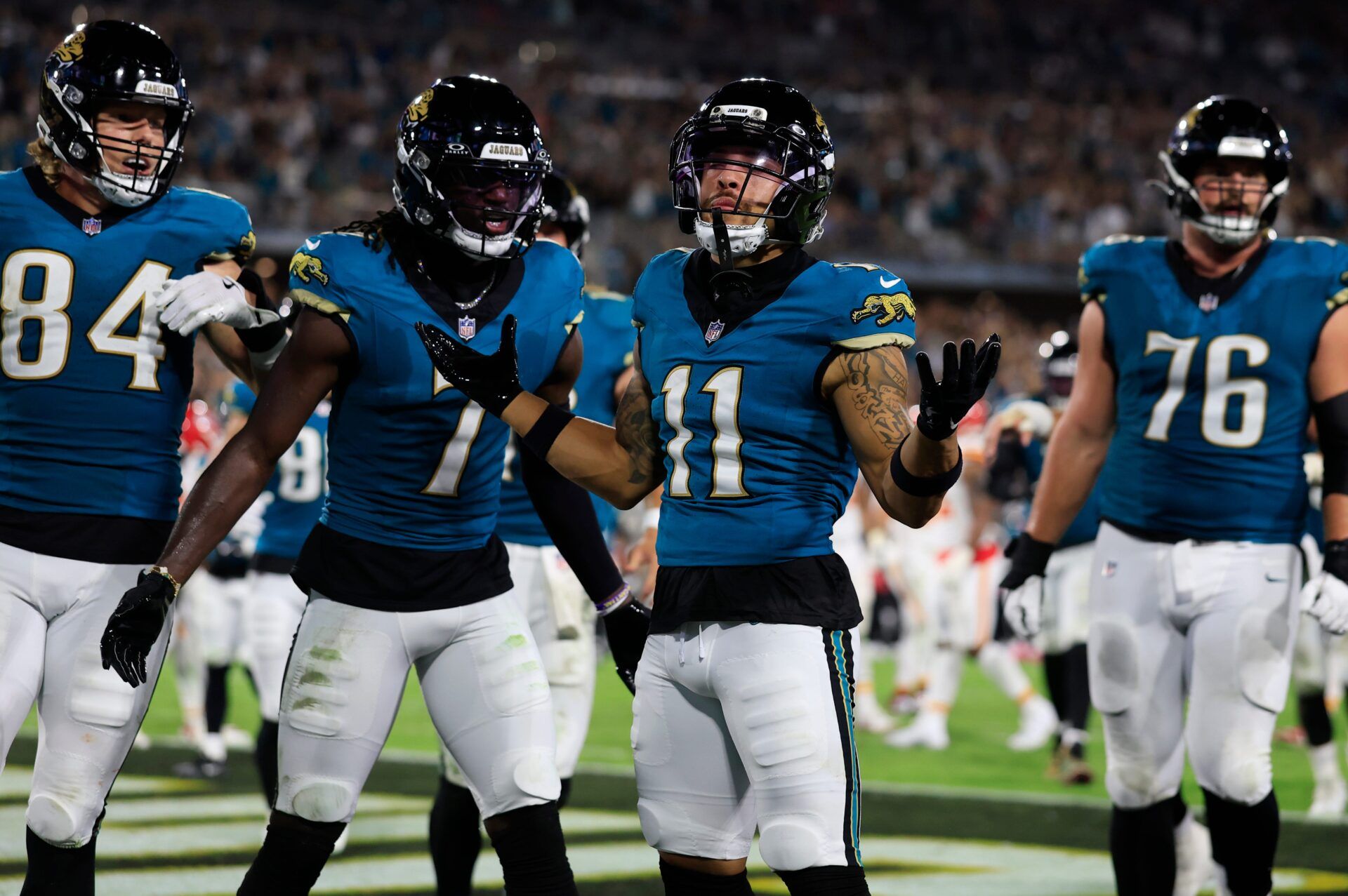 Jacksonville Jaguars wide receiver Parker Washington (11) celebrates his touchdown with wide receiver Brian Thomas Jr. (7), tight end Hunter Long (84) and guard Ezra Cleveland (76) during the second quarter of an NFL football matchup at EverBank Stadium, Monday, Oct. 6, 2025, in Jacksonville, Fla. The Jacksonville Jaguars edged the Kansas City Chiefs 31-28. [Corey Perrine/Florida Times-Union]